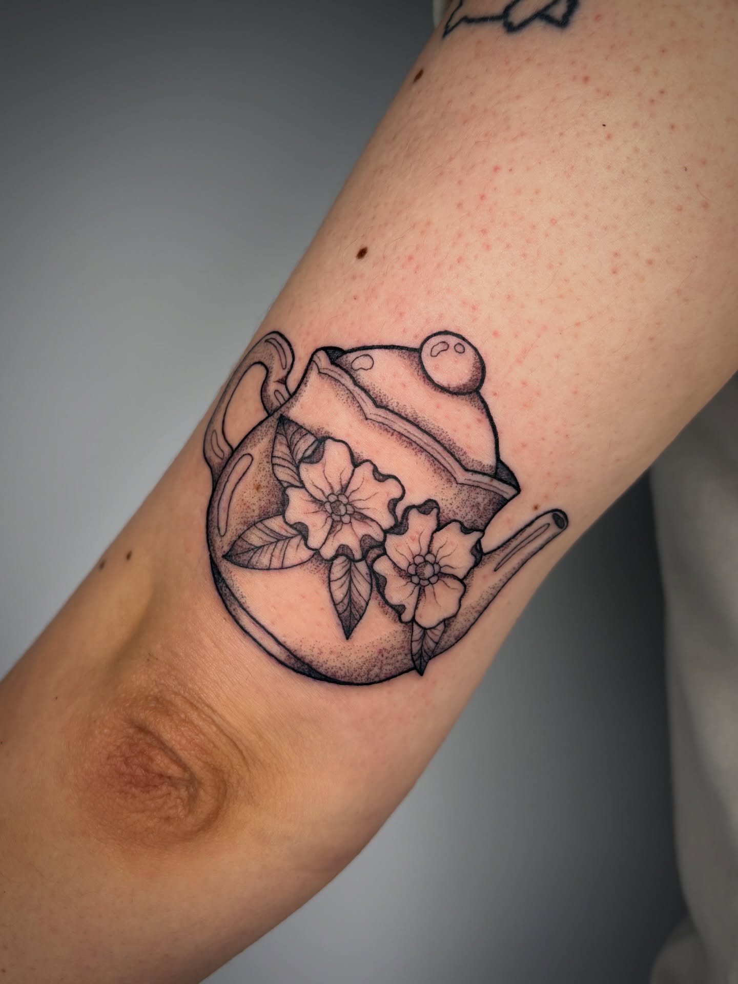 Tea pot with flowers dotwork tattoo on the forearm by Poppy Olivia Deards