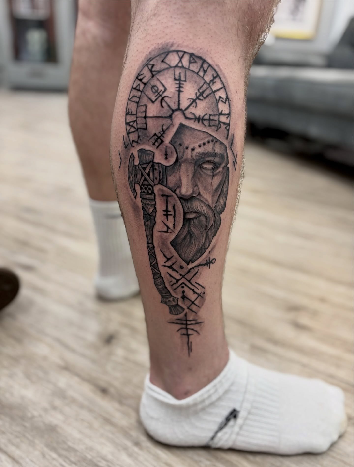Viking helmet and runes realism tattoo on the calf by Ruth Ormsby-Ashworth