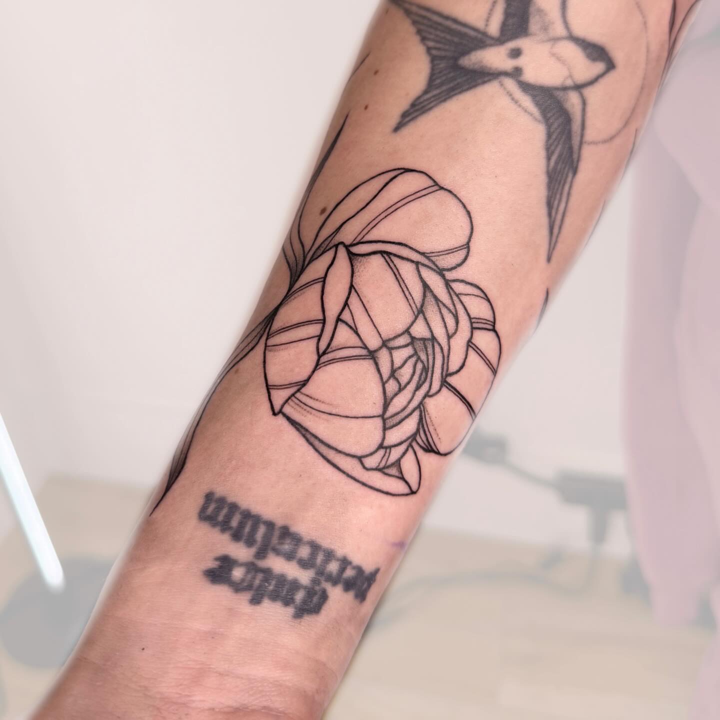 Lotus flower geometric tattoo on the forearm by Nika