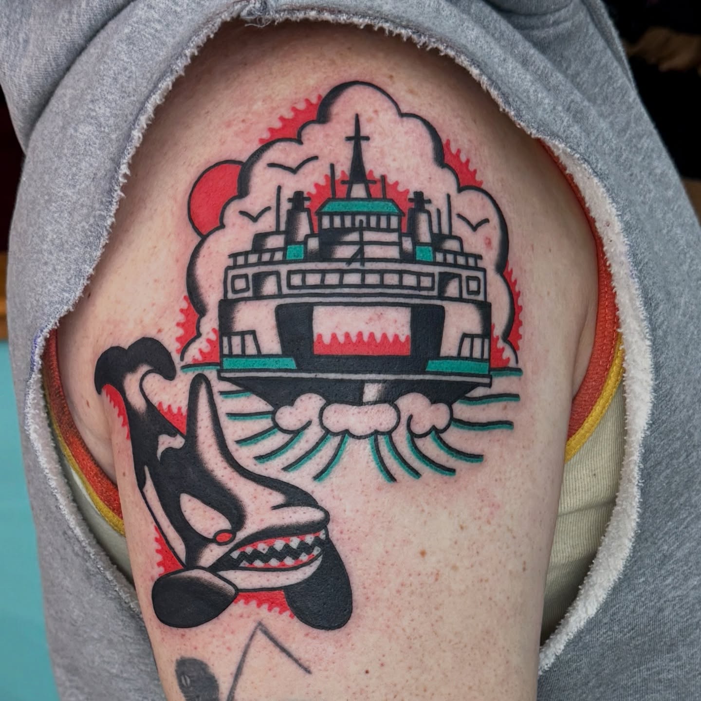 Ship and whale American traditional tattoo on the upper arm by Sam