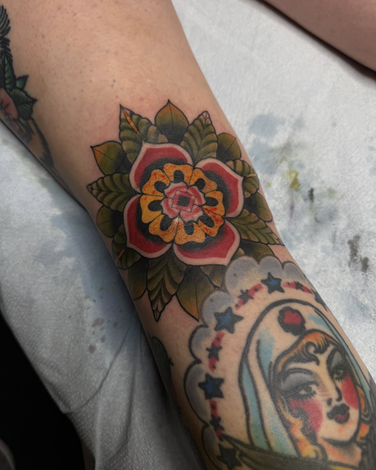 Floral design American traditional tattoo on the forearm by Sean Cavanaugh