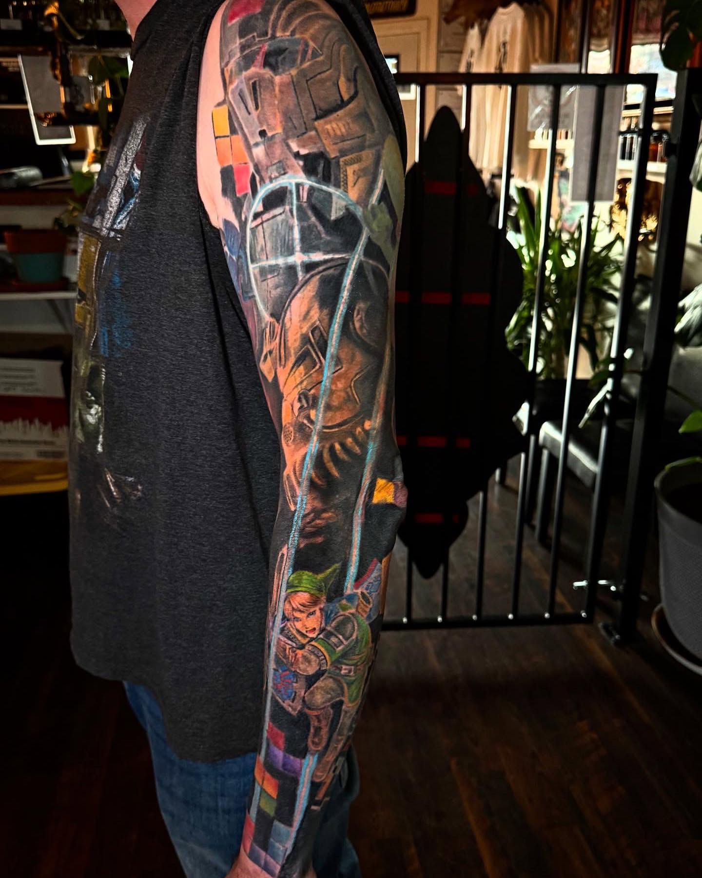 Mechanical armor and link realism tattoo on the upper arm by Sean Cavanaugh