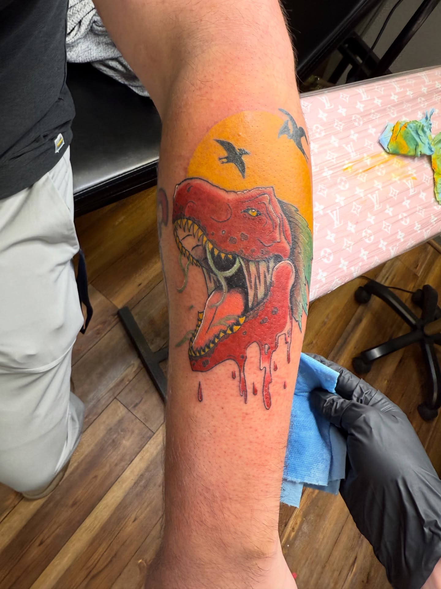 Dinosaur new school tattoo on the forearm by Palmer Andrist🩸Fort Collins Tattoo Apprentice