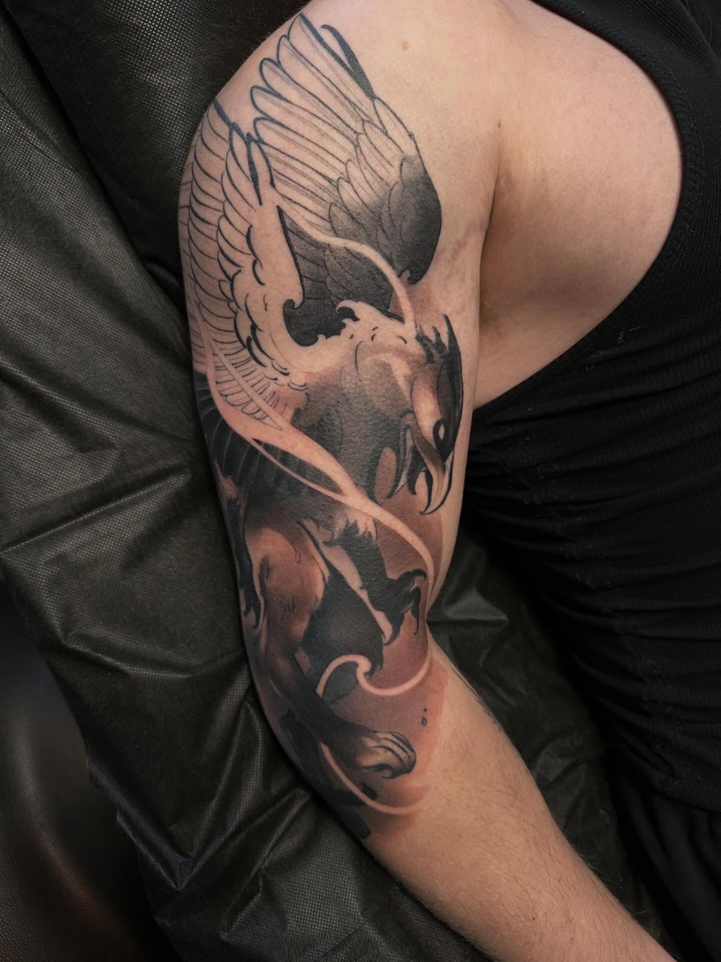 Phoenix black and grey tattoo on the forearm by Nathan Adsit
