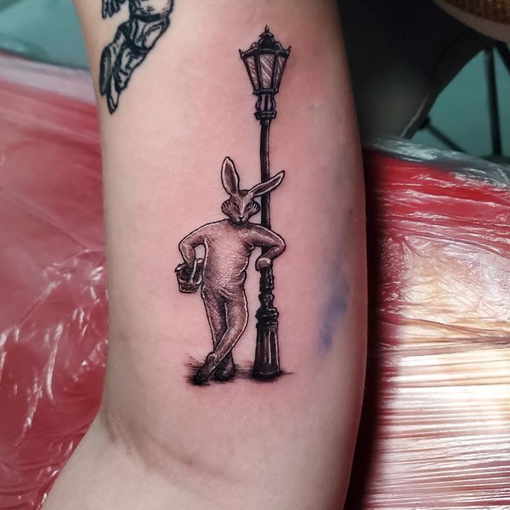 Rabbit leaning on street lamp black and grey tattoo on the forearm by Matthew Ray, Harrisburg, North Carolina