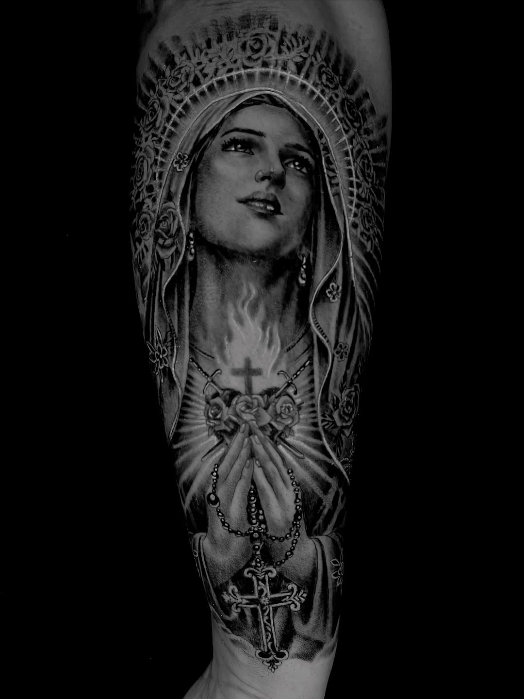 Virgin Mary with rosary Chicano tattoo on the forearm by Tattoo Artist