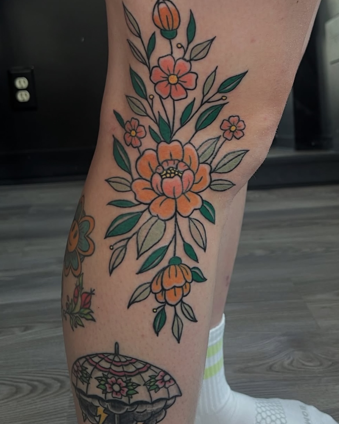 Floral bouquet American traditional tattoo on the leg by Rachel Hanke