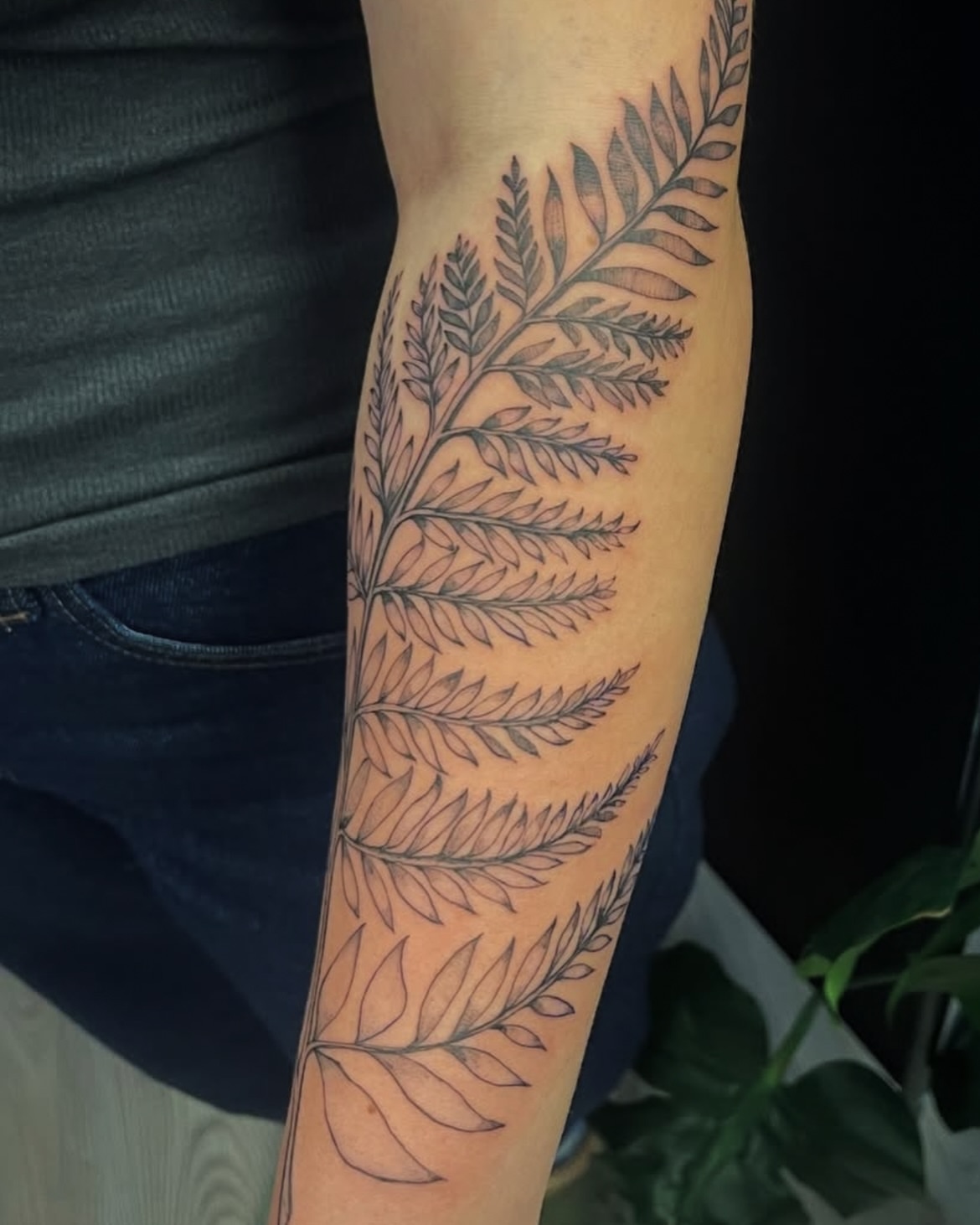 Fern black and grey tattoo on the forearm by Rachel Hanke