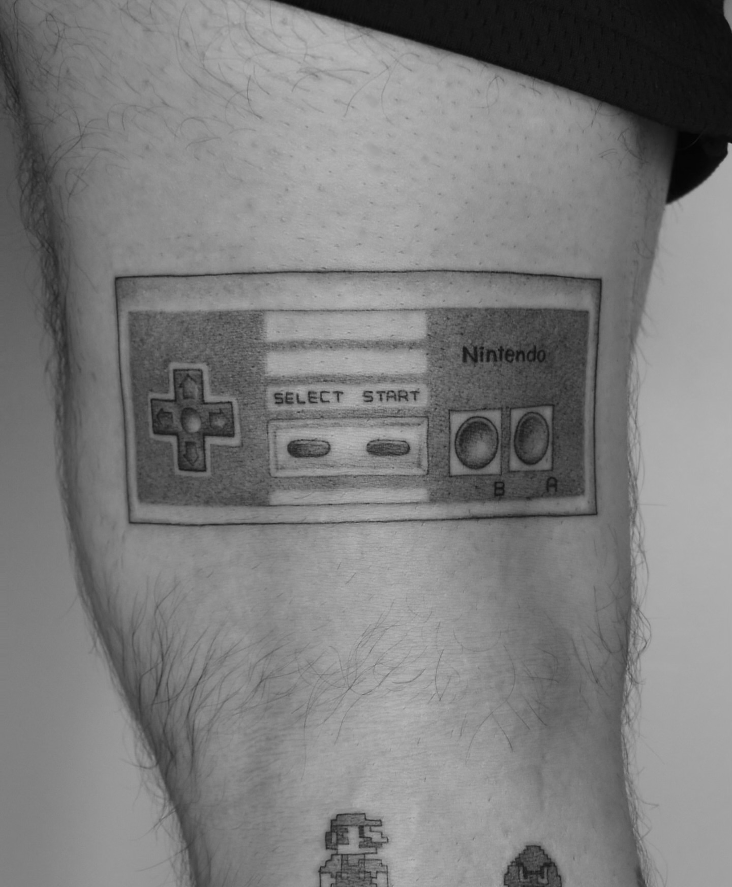 NES controller black and grey tattoo on the forearm by ☆ Nashville Fine Line Tattoo Artist ☆
