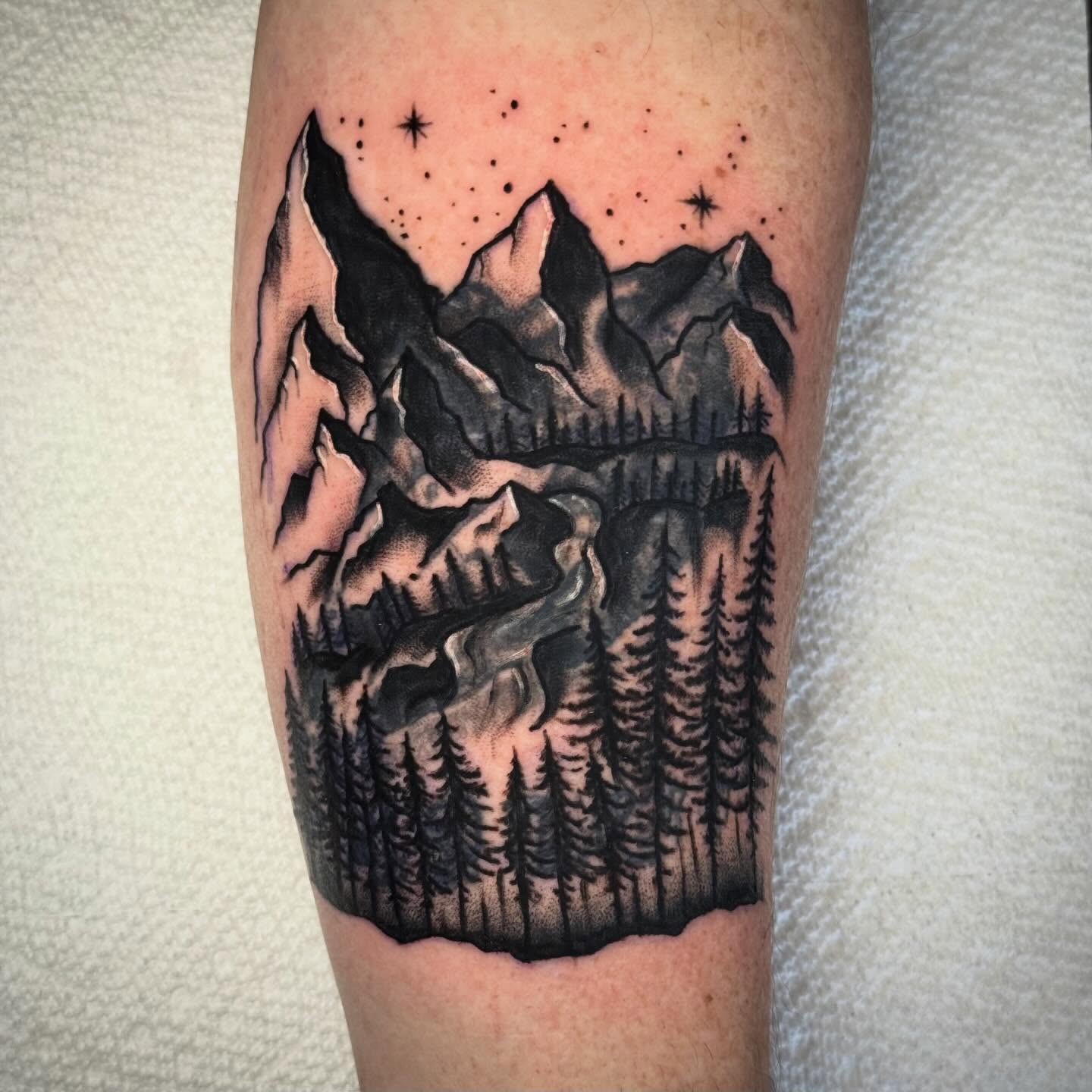 Mountain landscape dotwork tattoo on the forearm by Ty Elias