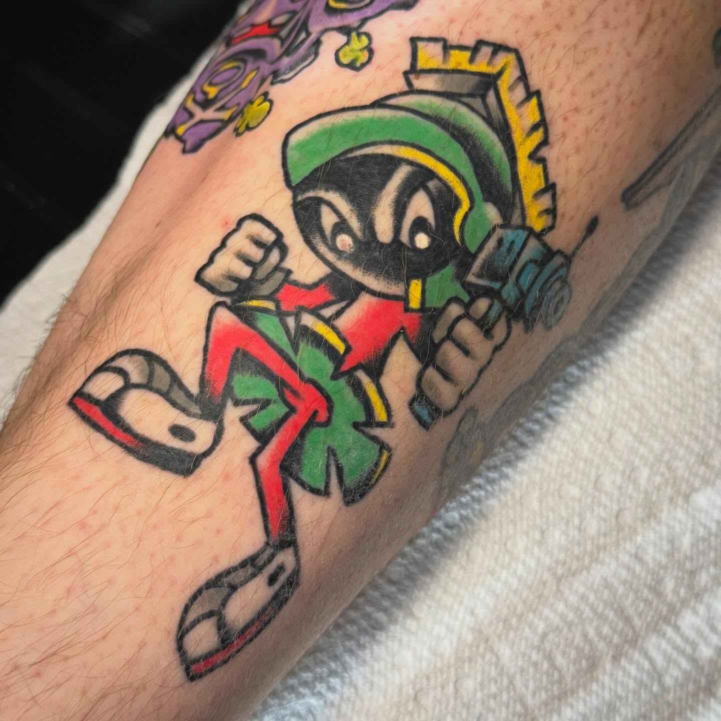 Cartoon character American traditional tattoo on the forearm by Ty Elias
