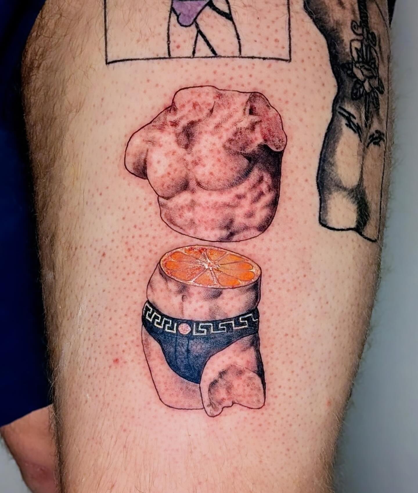 Muscle and orange slice realism tattoo on the leg by Shannon