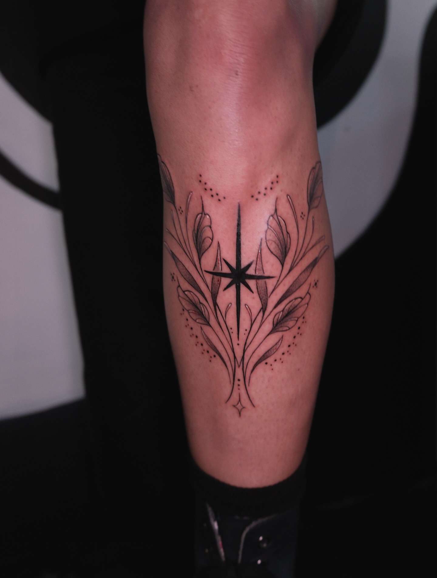 Star and leaves dotwork tattoo on the forearm by Velvet, Seattle, Washington