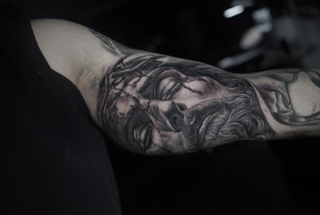 Religious figure realism tattoo on the forearm by Niko Hosk Cataldo