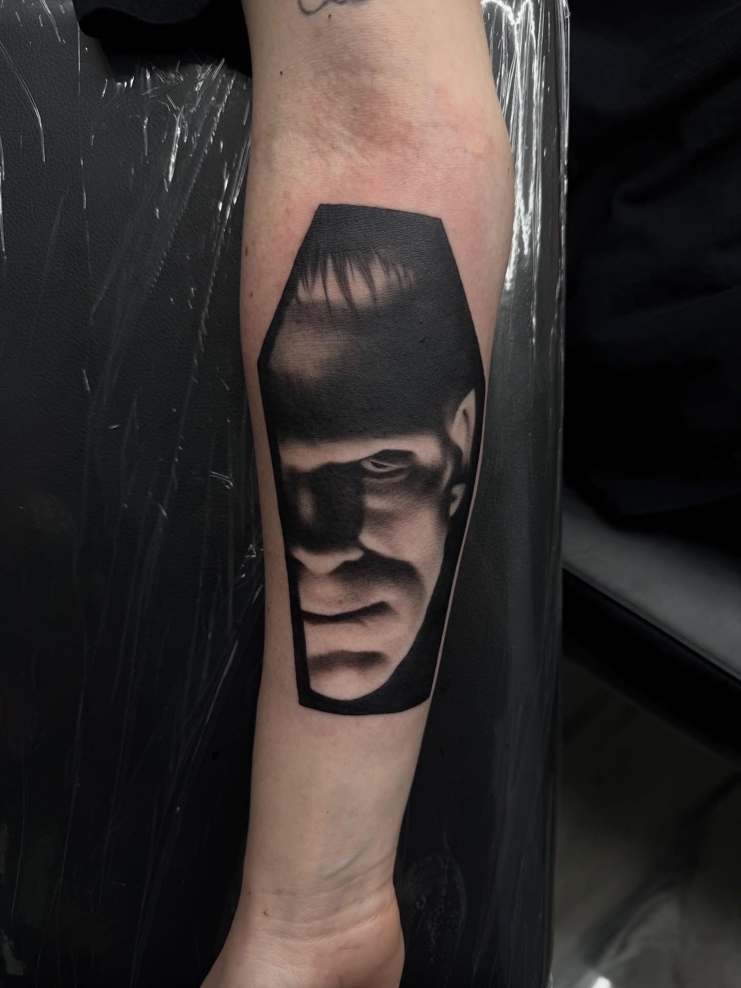 Man's face realism tattoo on the forearm by Nick Campbell