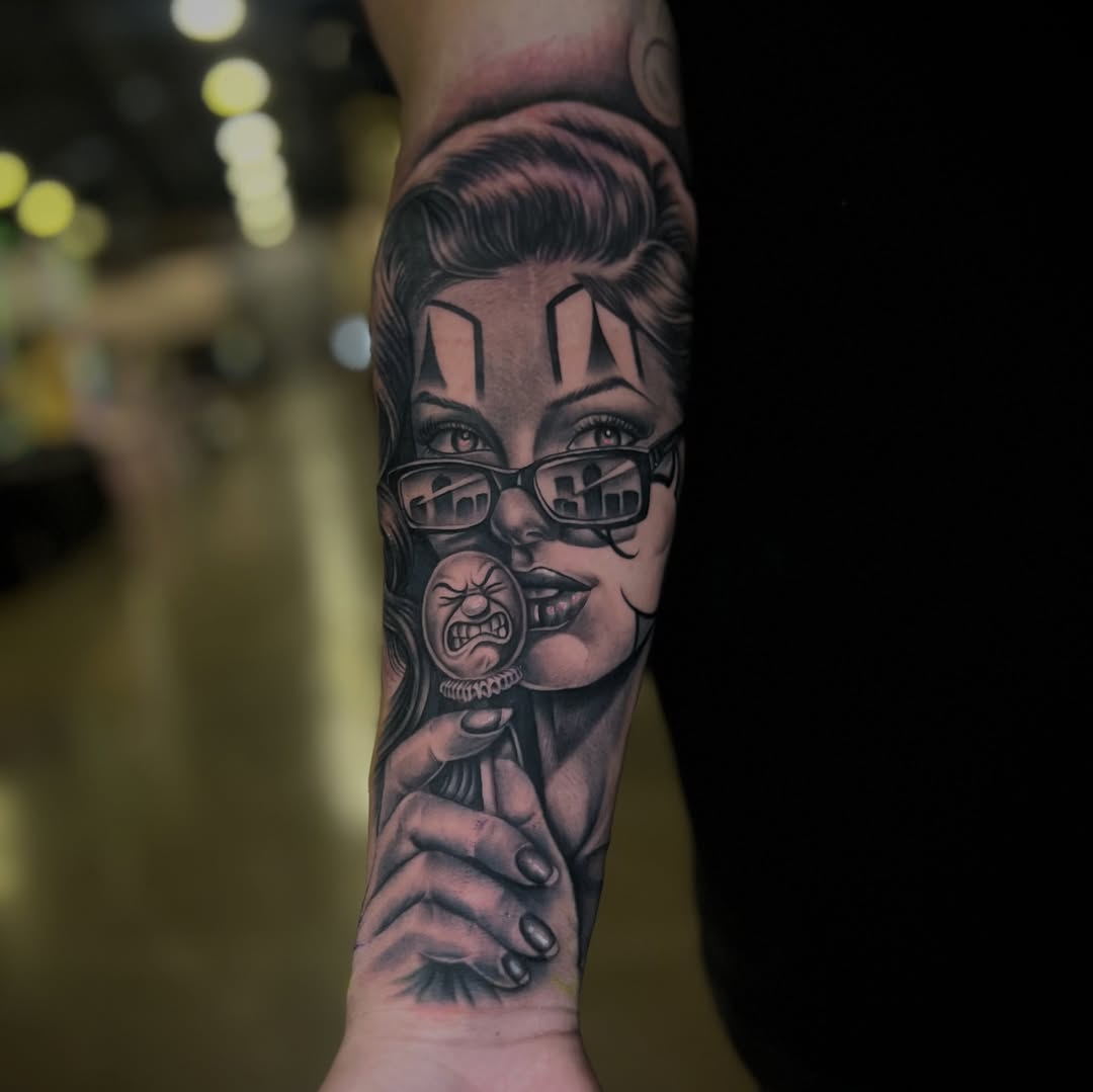 Woman with clown makeup and lollipop Chicano tattoo on the forearm by LOS