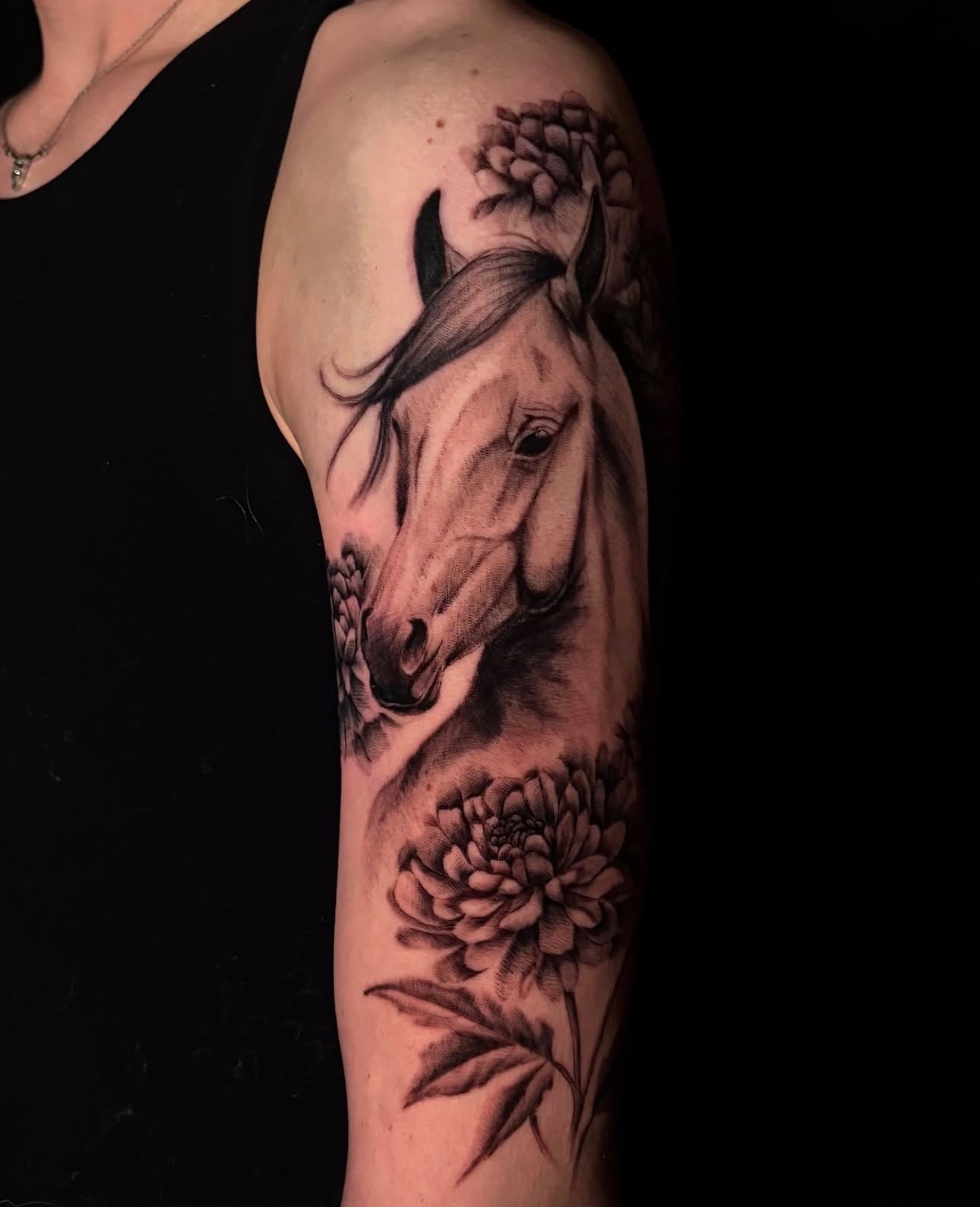 Horse and flowers realism tattoo on the forearm by Angel Tattoos