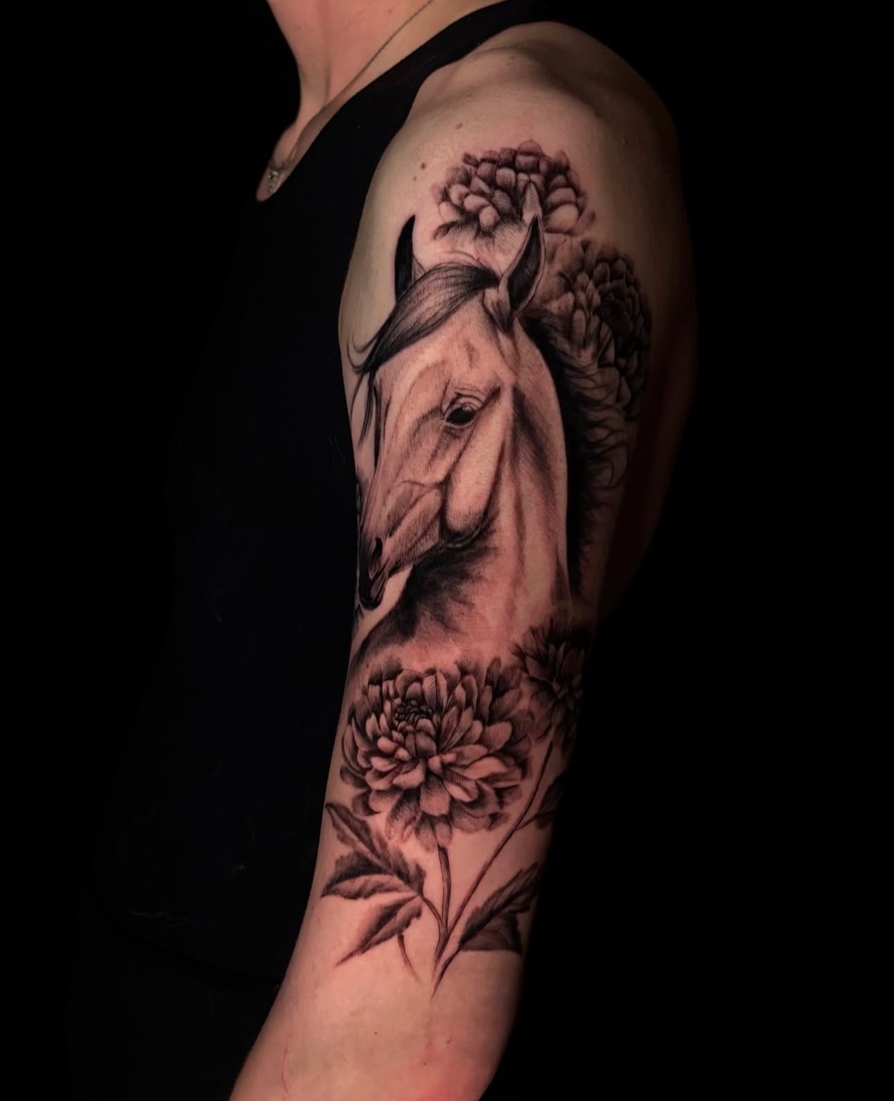 Horse and flowers realism tattoo on the forearm by Angel Tattoos