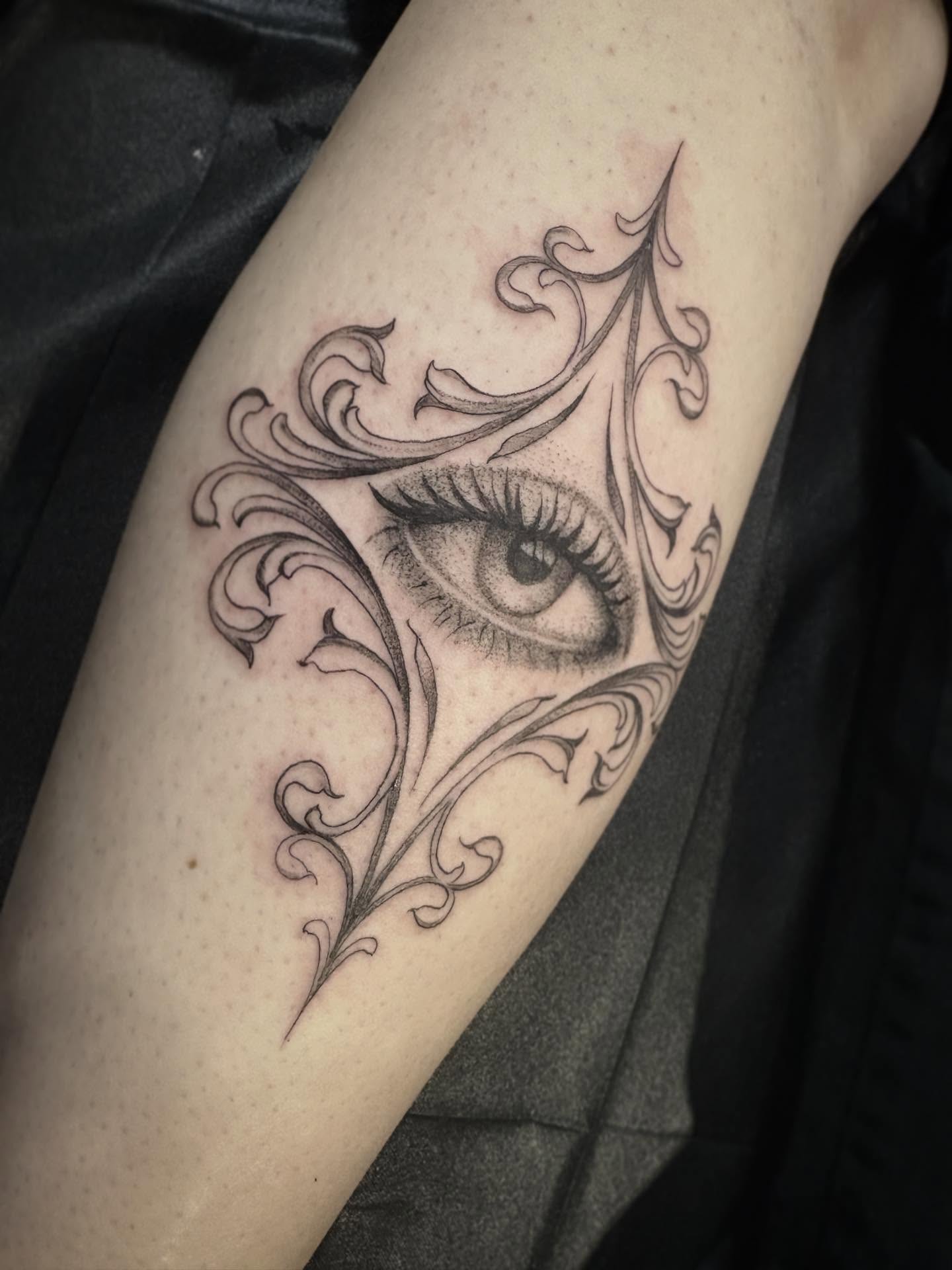 Eye with swirls realism tattoo on the forearm by Cassandra Colleen