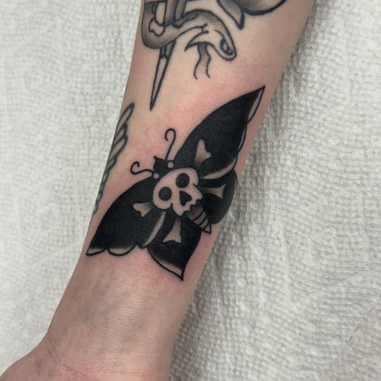 Butterfly with skull American traditional tattoo on the forearm by Ben