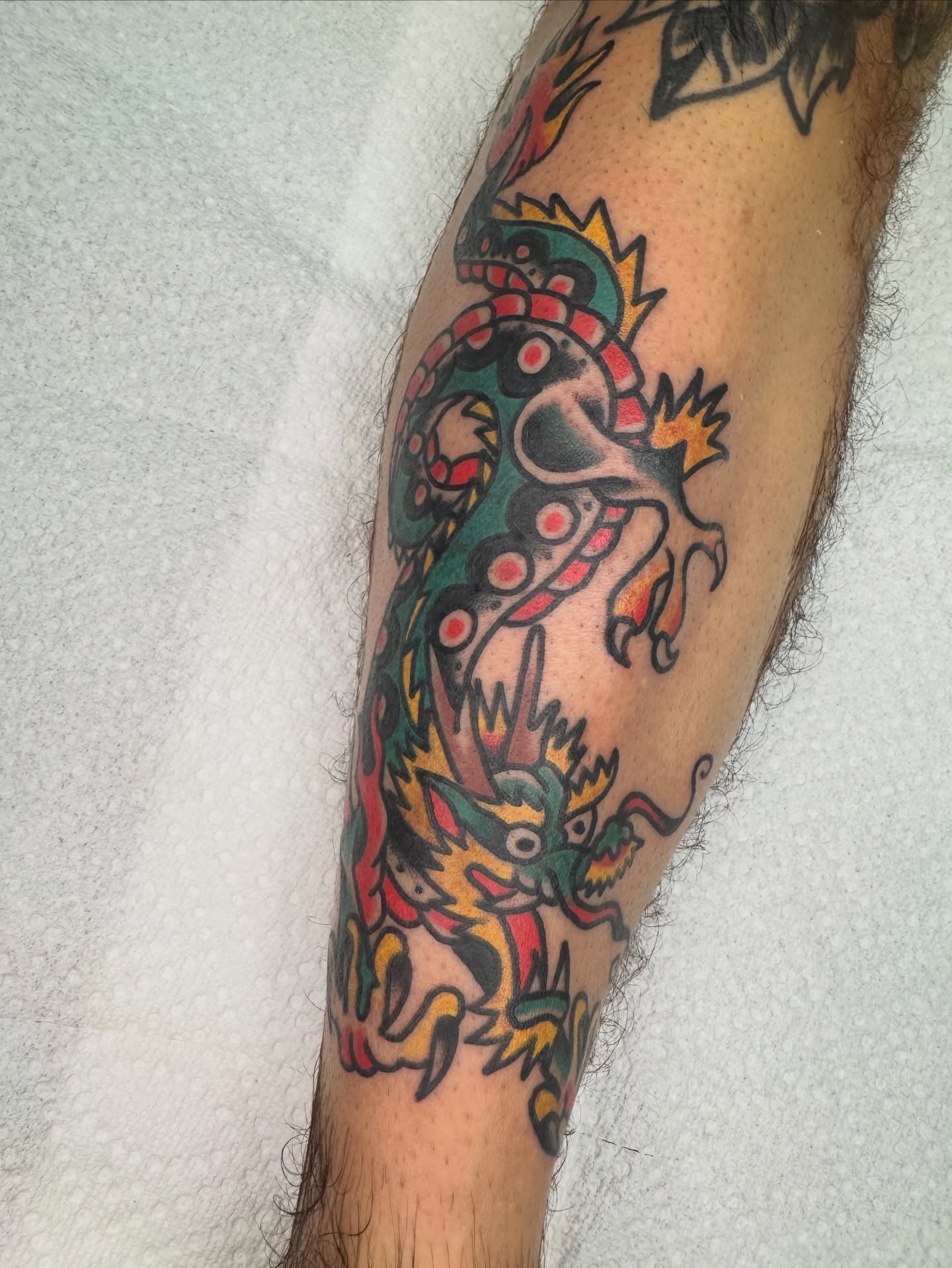 Dragon American traditional tattoo on the forearm by Kenny Kastro