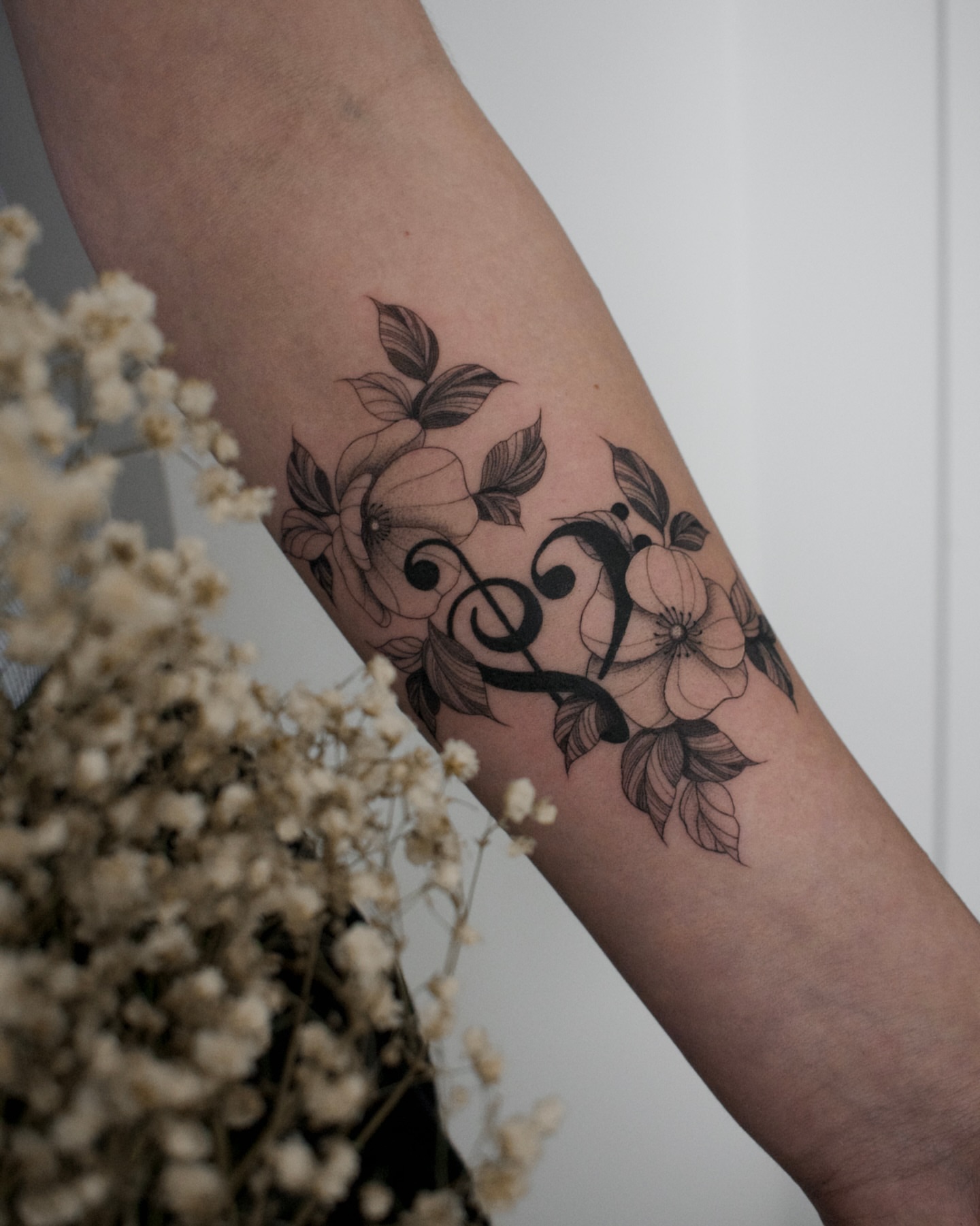 Floral vine black and grey tattoo on the forearm by Haley Sayers