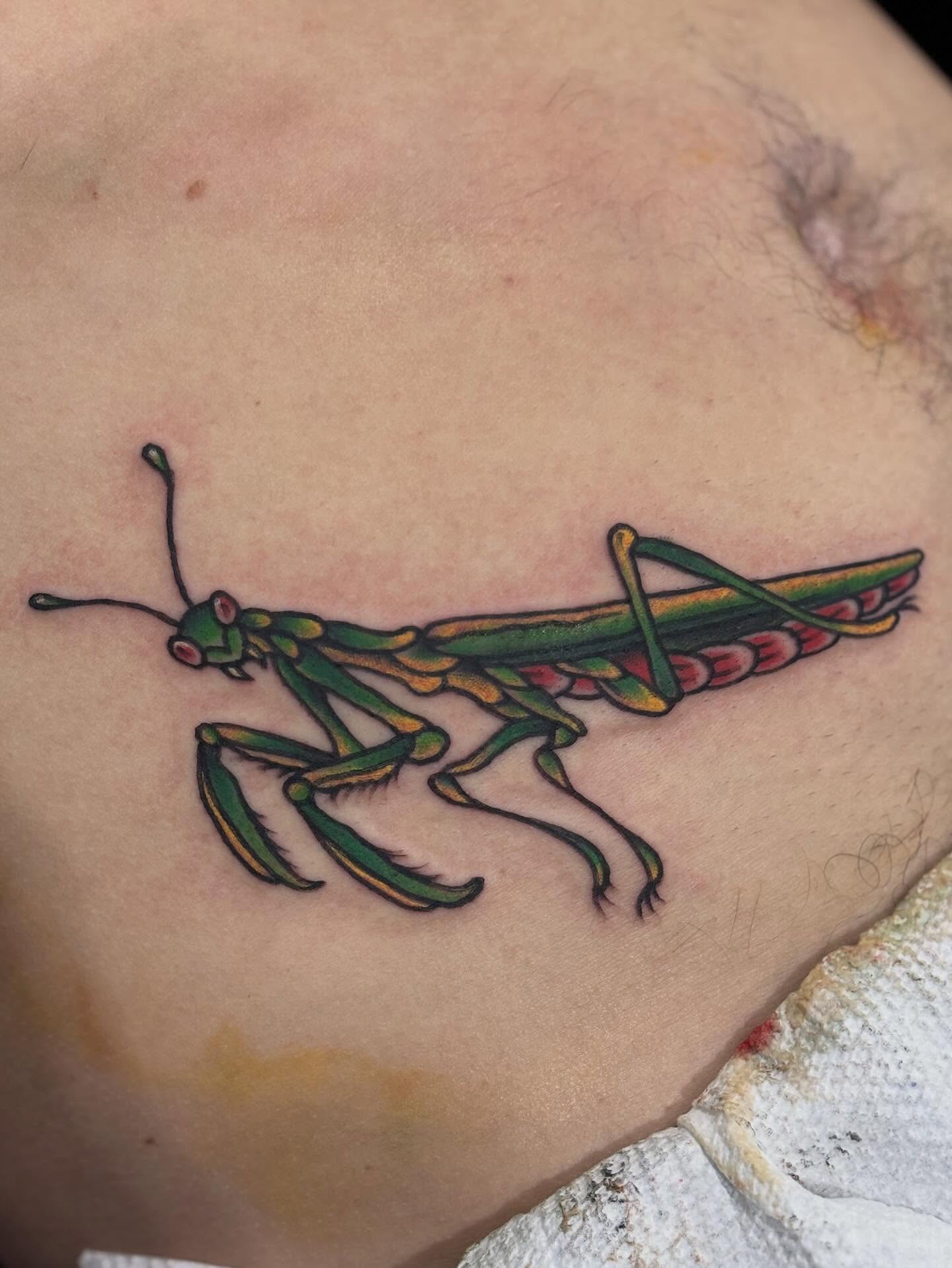Praying mantis American traditional tattoo on the chest by Nick Tate