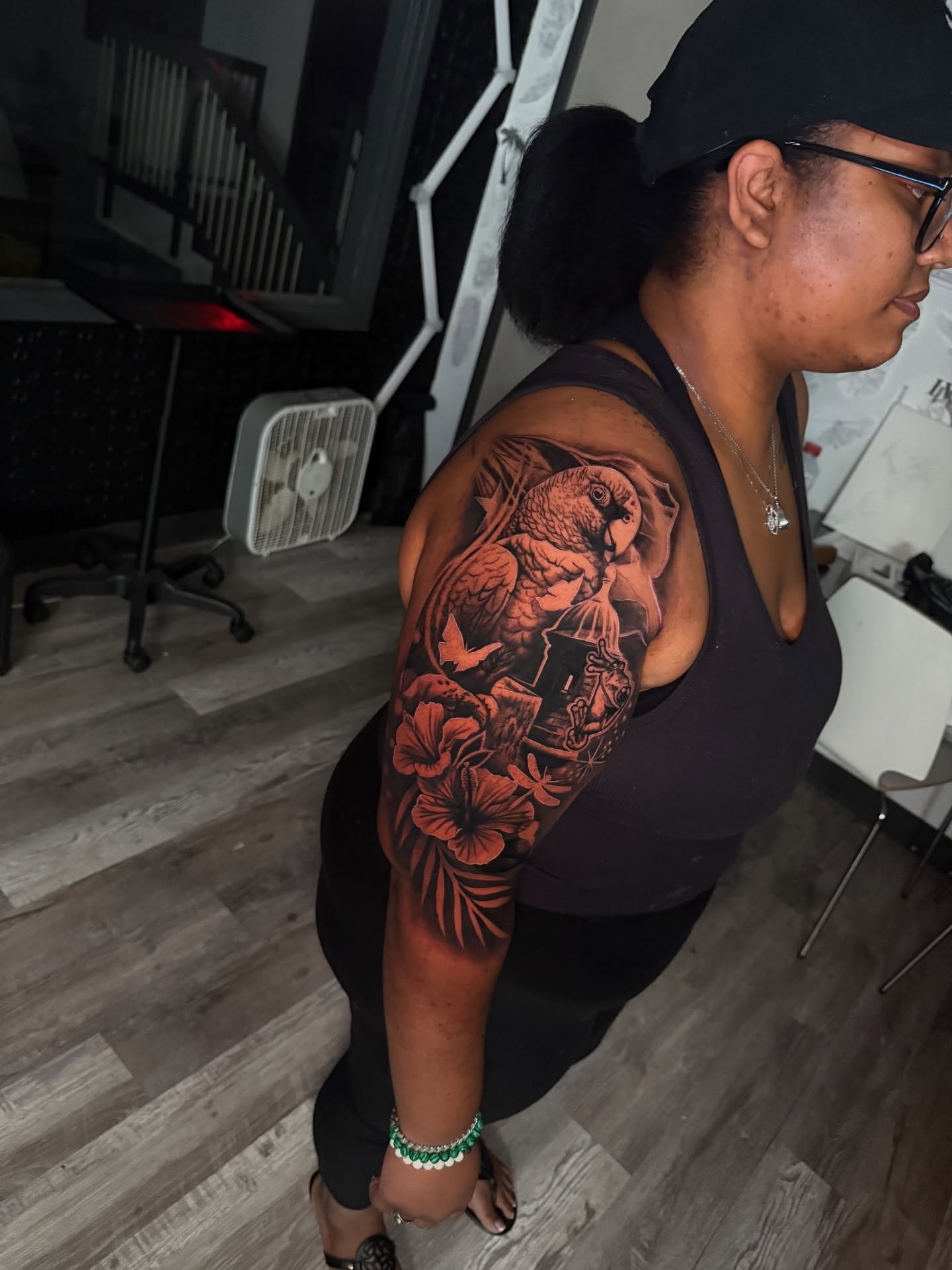 Parrot and flowers realism tattoo on the shoulder by Atlanta Tattoo Artist