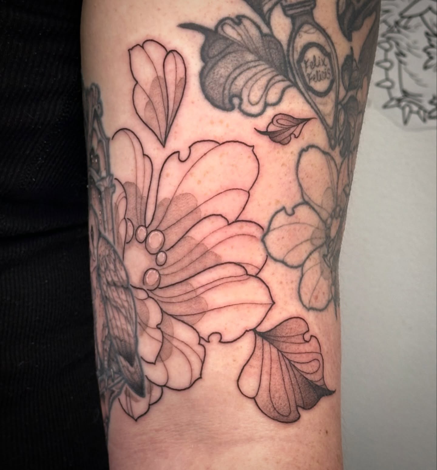 Floral arrangement black and grey tattoo on the forearm by TATTOOLIZARD (James)