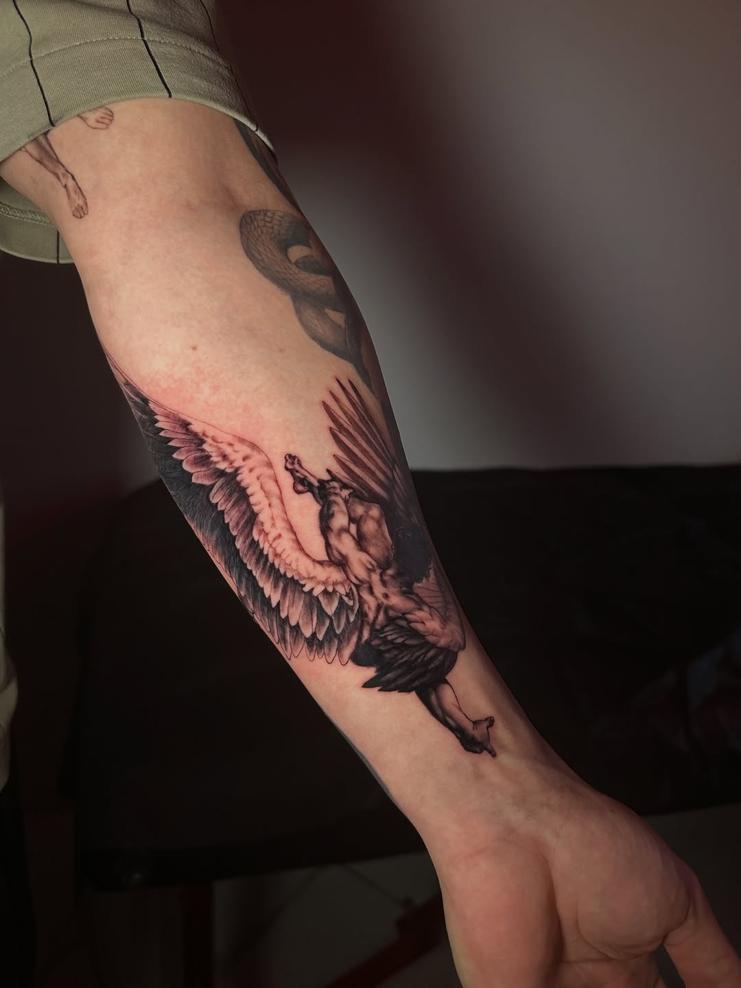 Angelic figure with wings realism tattoo on the forearm by Dennis Alejandro