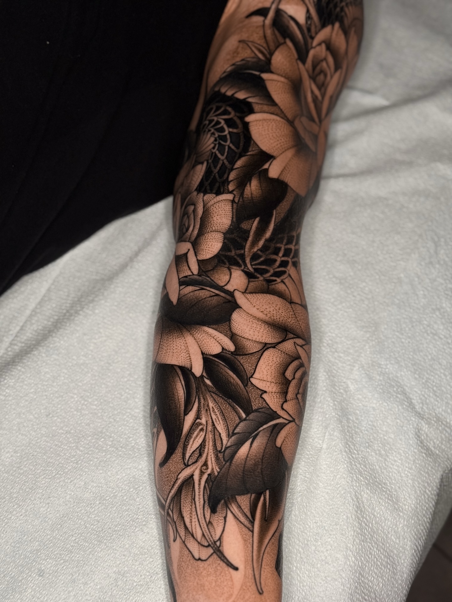 Floral bouquet realism tattoo on the forearm by San Diego