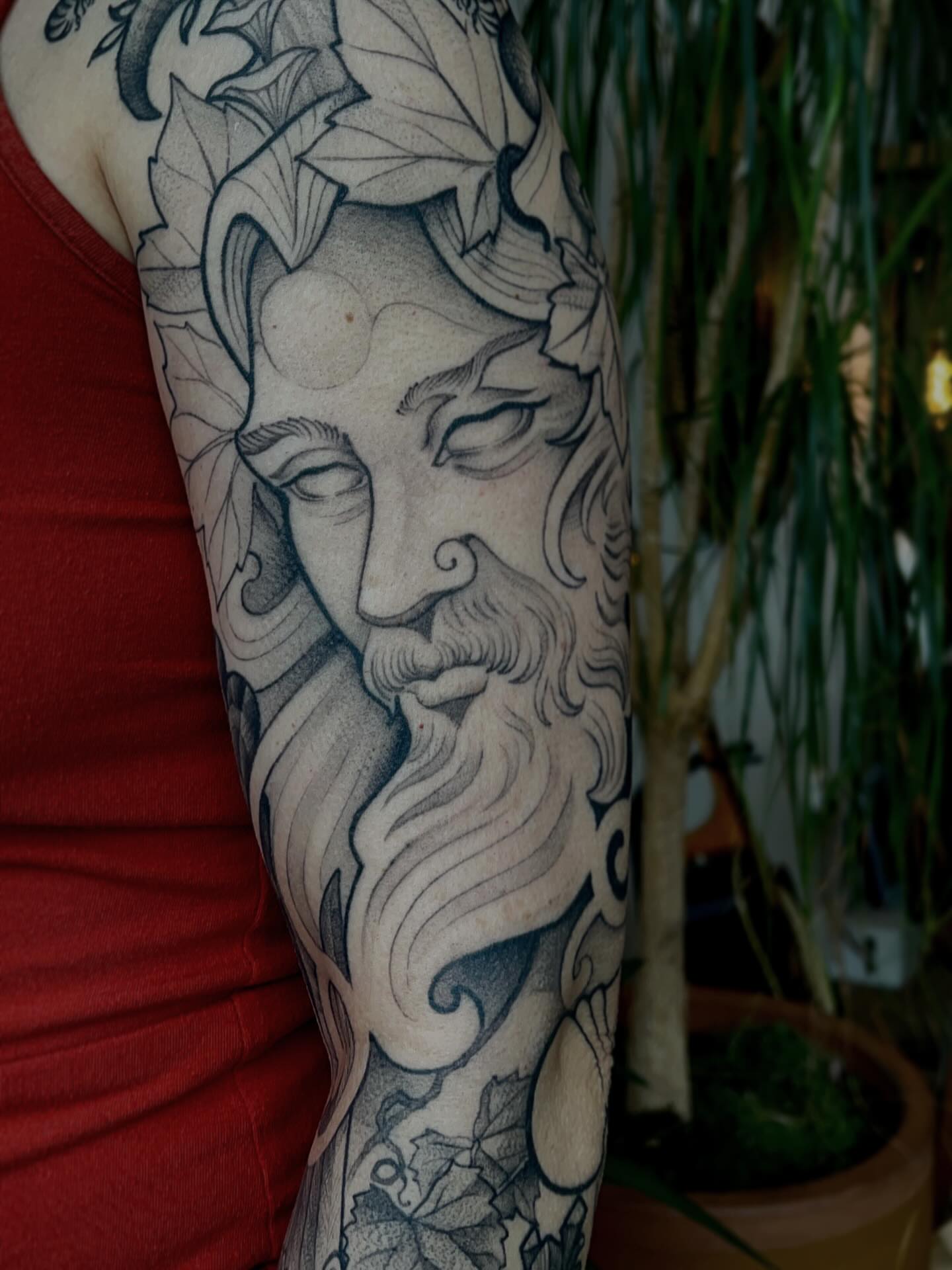 God-like face black and grey tattoo on the forearm by Samantha Castrovinci, Durham, North Carolina