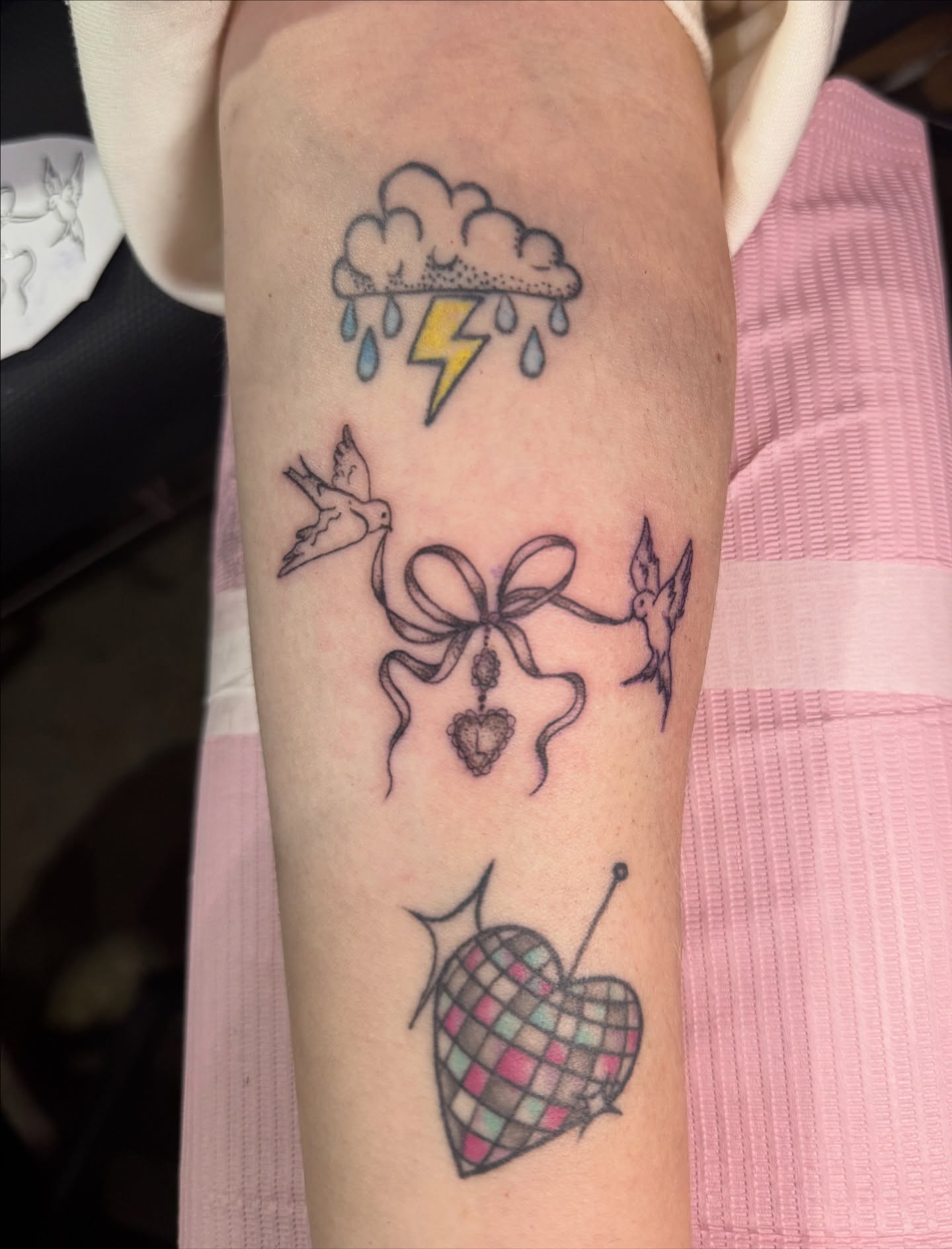 Heart with knitting needles geometric tattoo on the forearm by Tara Woods