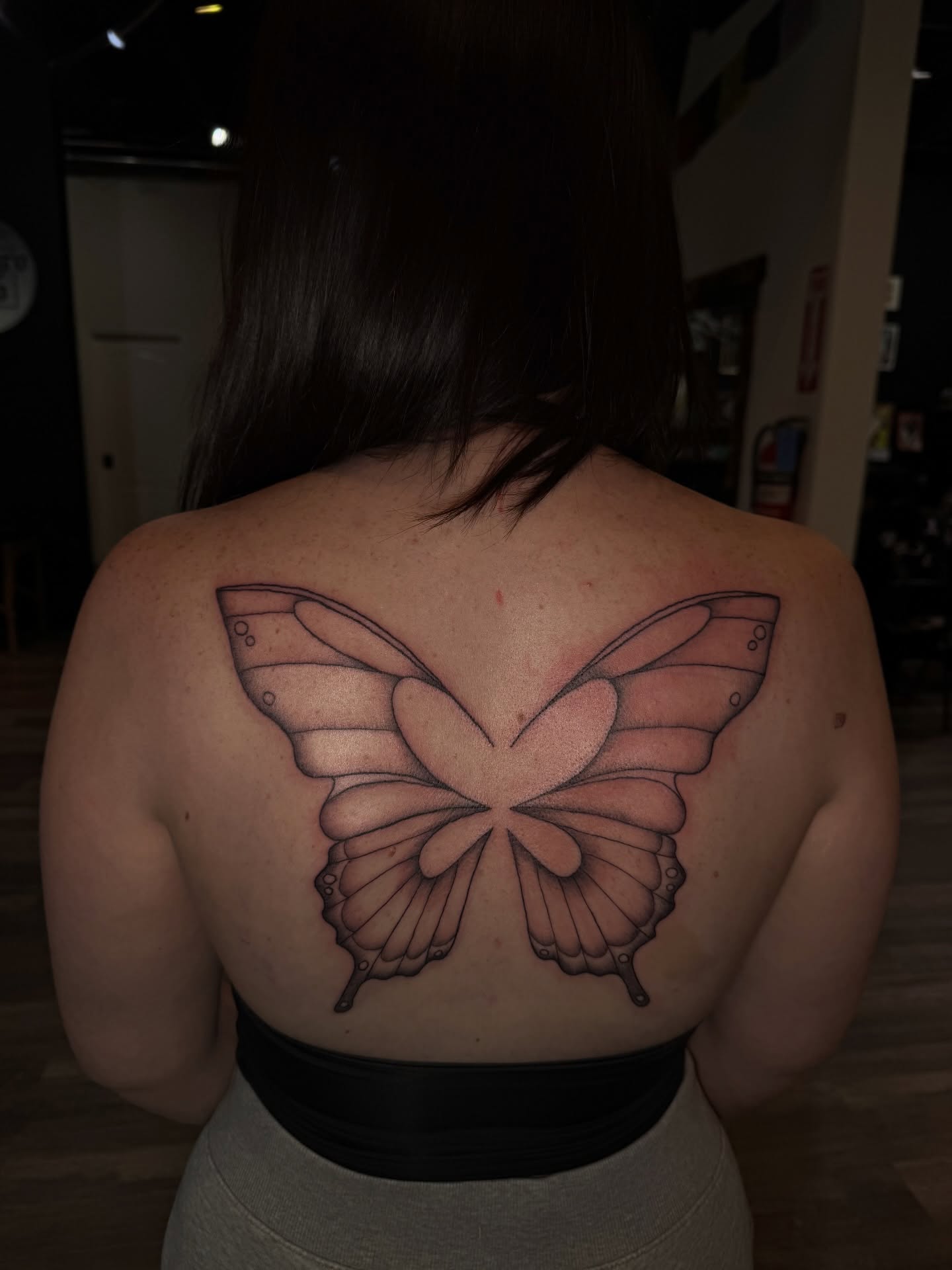 Butterfly black and grey tattoo on the back by Nathalie Briseno