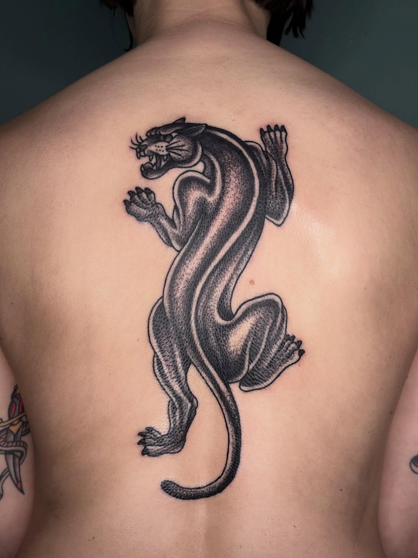 Panther black and grey tattoo on the back by Sydney Pflaumer
