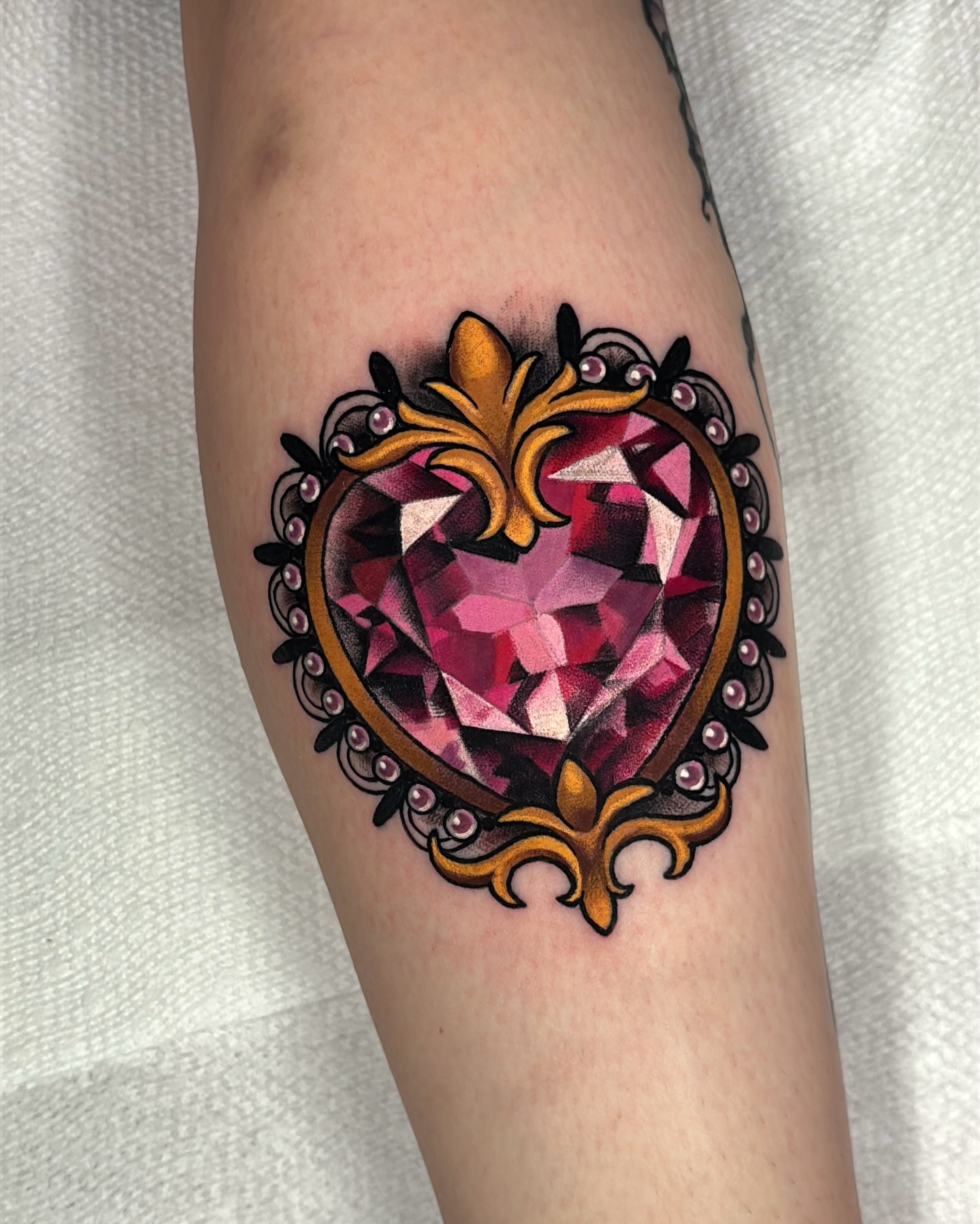 Gemstone geometric tattoo on the forearm by Latesha Burnley