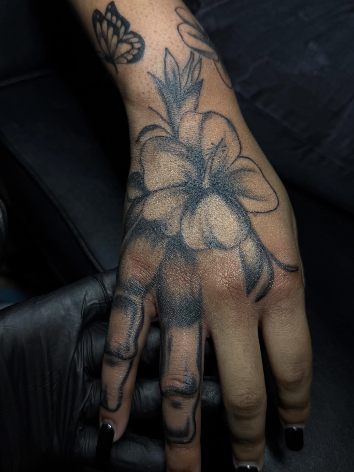 Flower black and grey tattoo on the hand by Destini