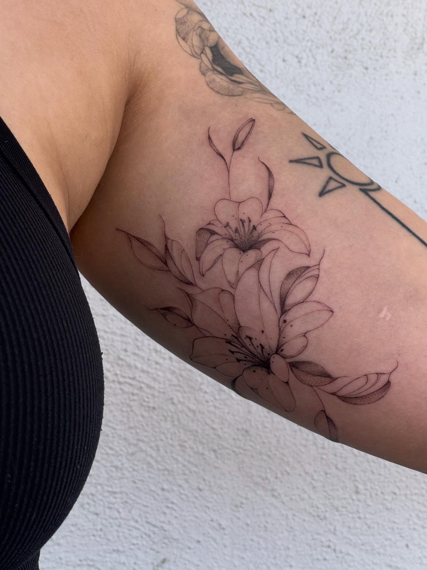 Lilies black and grey tattoo on the forearm by Karina ⋆⭒˚.⋆