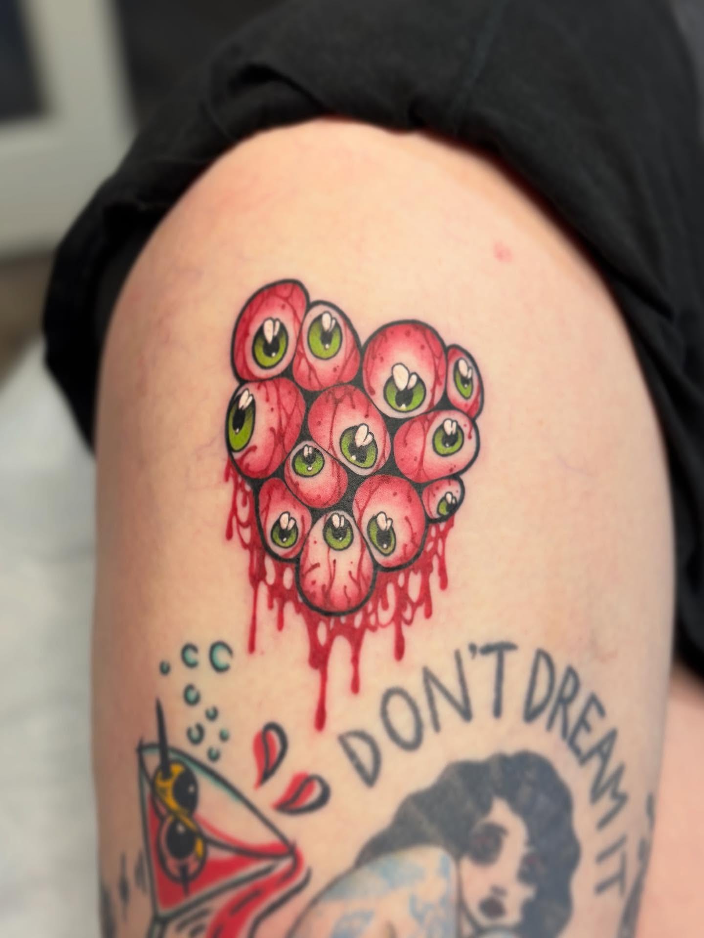 Eyes dotwork tattoo on the thigh by Riley Borne