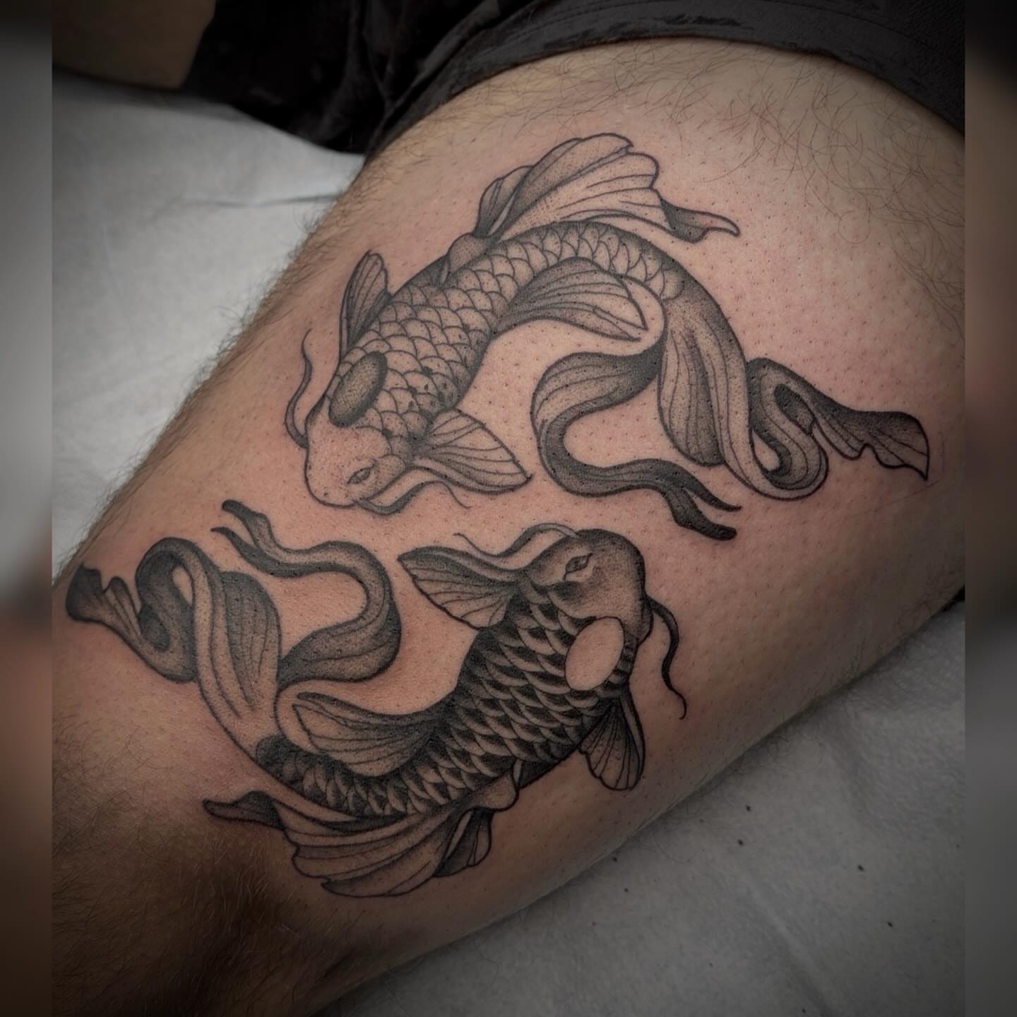 Koi fish black and grey tattoo on the thigh by Alyssa Deeghan