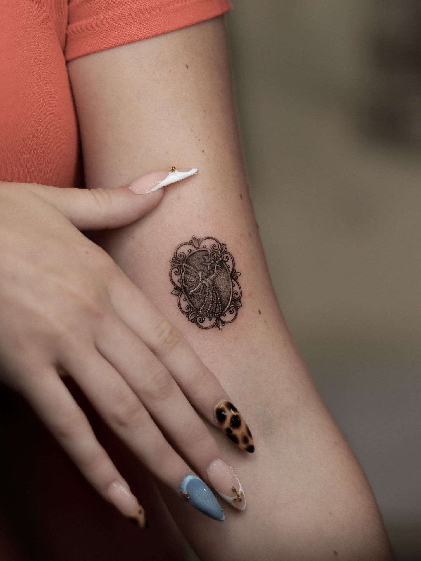 Peacock black and grey tattoo on the forearm by Arthur Kossoski