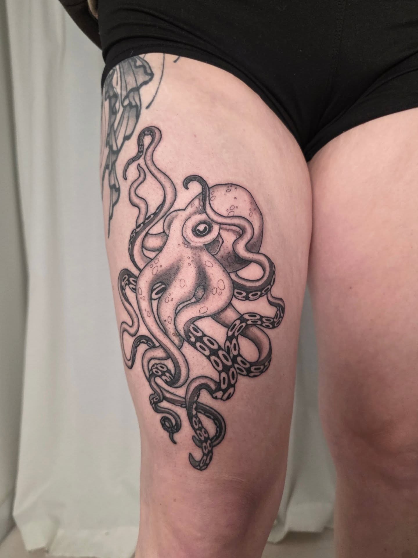 Octopus black and grey tattoo on the thigh by April High ☆ Tattoo Artist