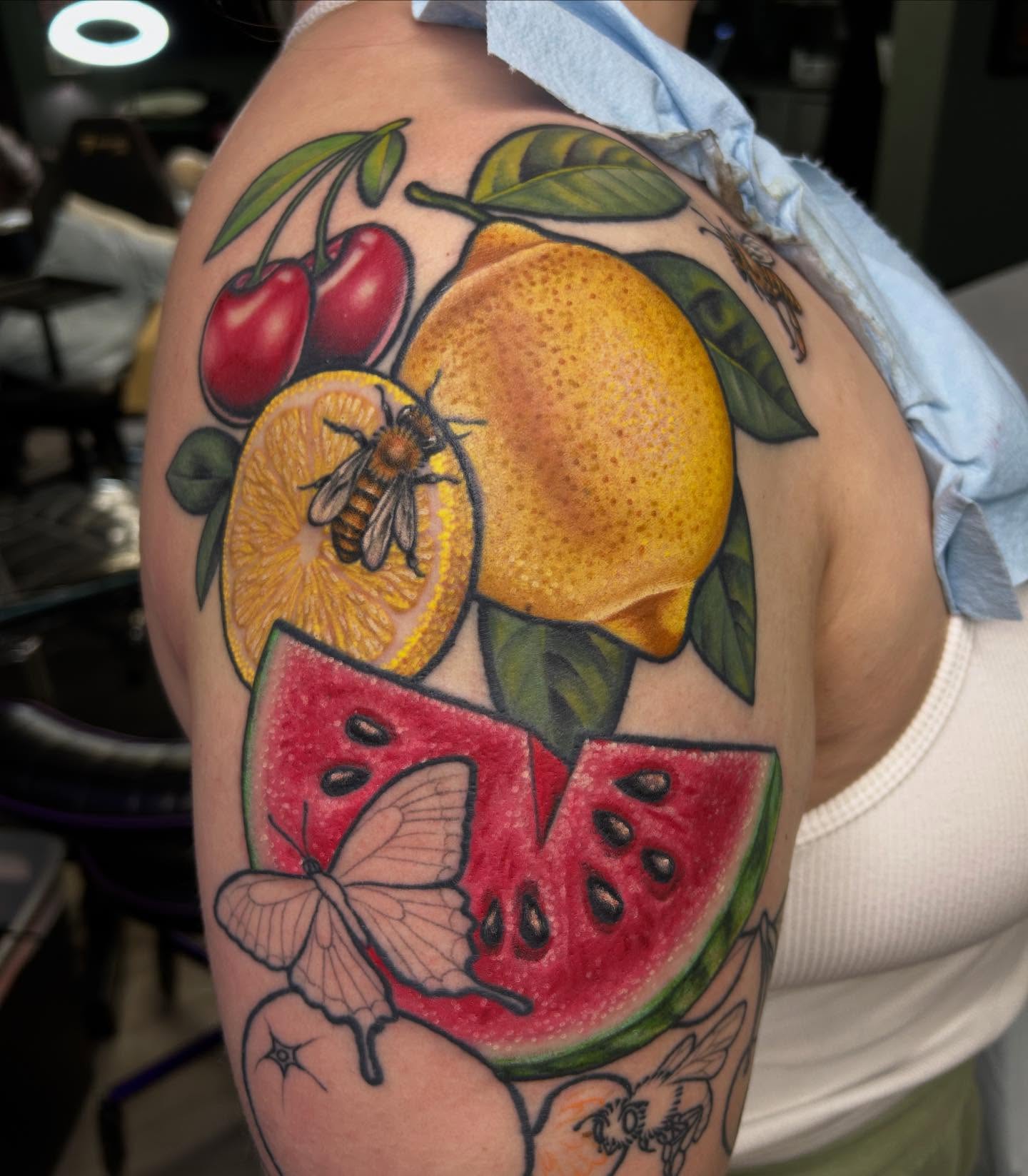 Fruit and insects American traditional tattoo on the shoulder by Mary Rose Heckle