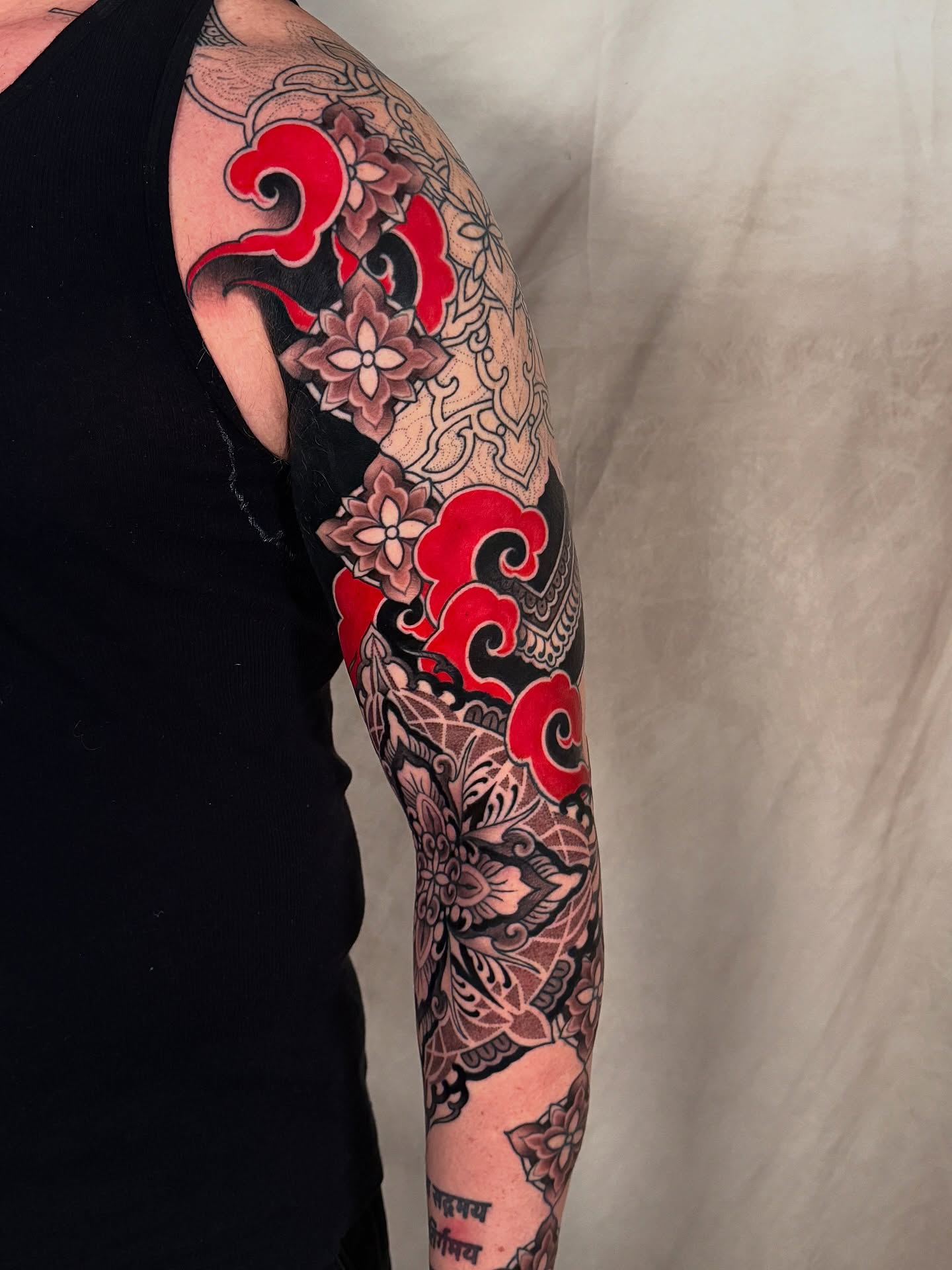 Wave and floral japanese irezumi tattoo on the upper arm by <