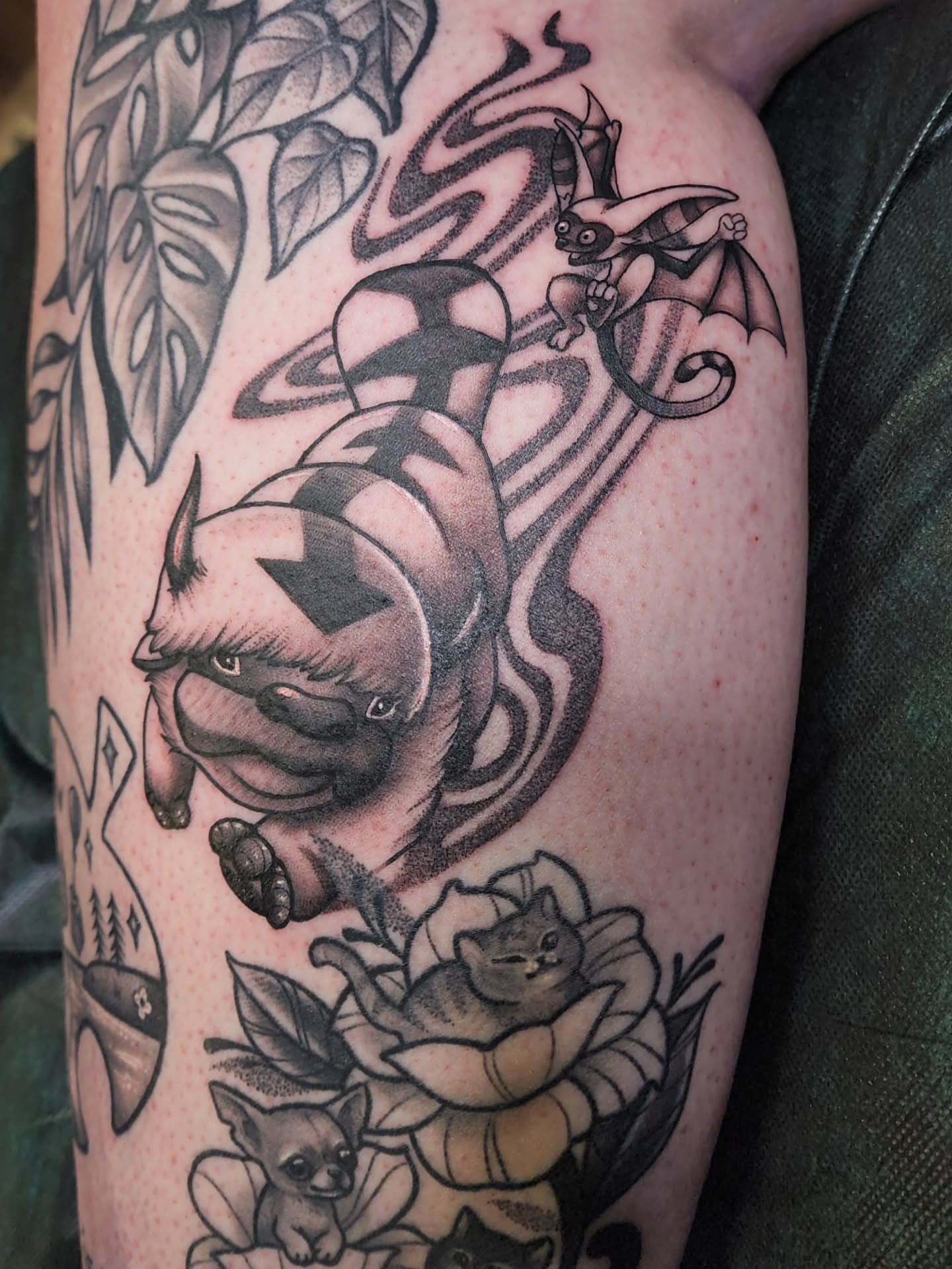 Monstera leaves and mythical creatures realism tattoo on the forearm by Shawna Goettsche