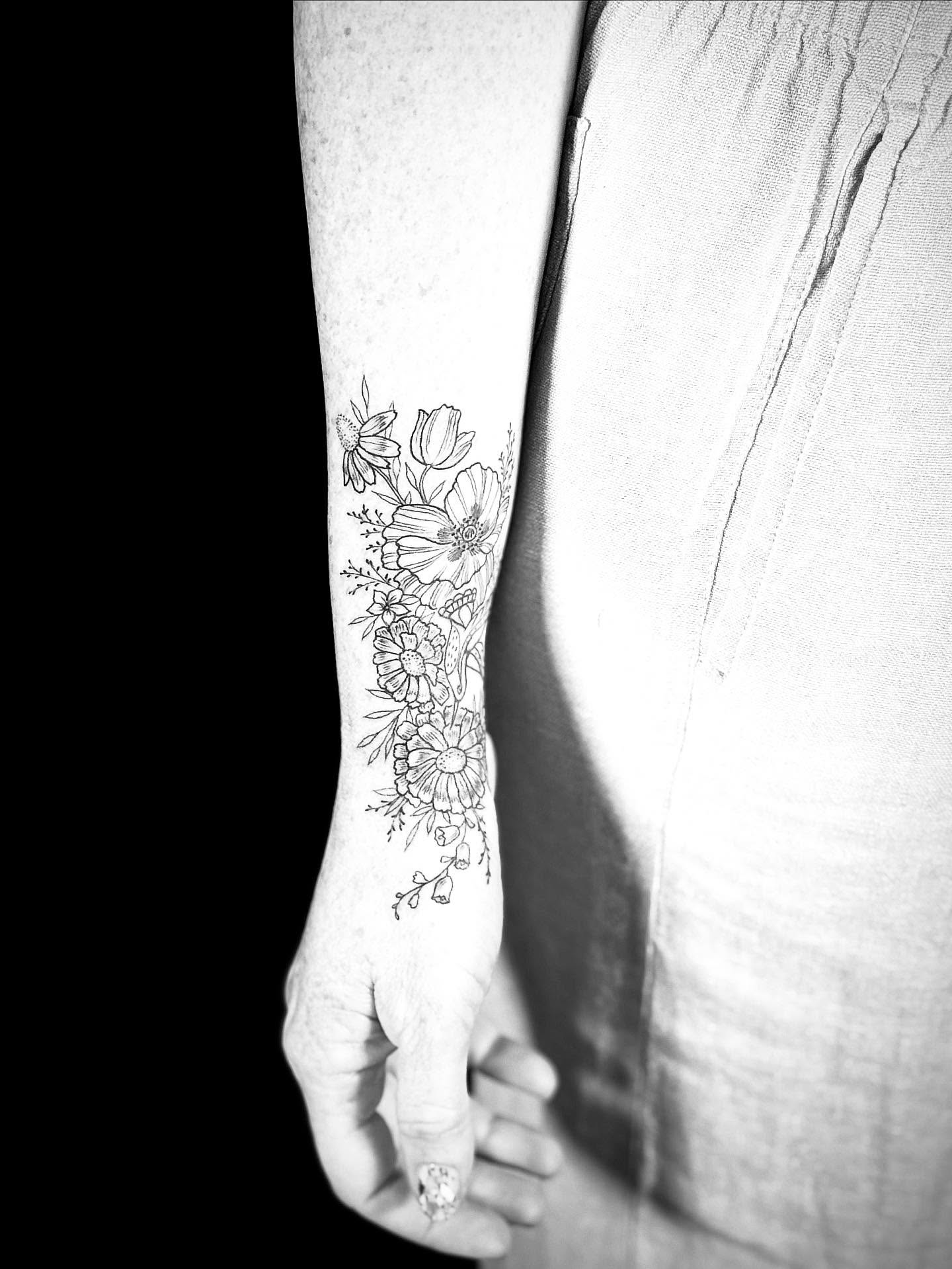 Floral bouquet black and grey tattoo on the forearm by Annie Mess