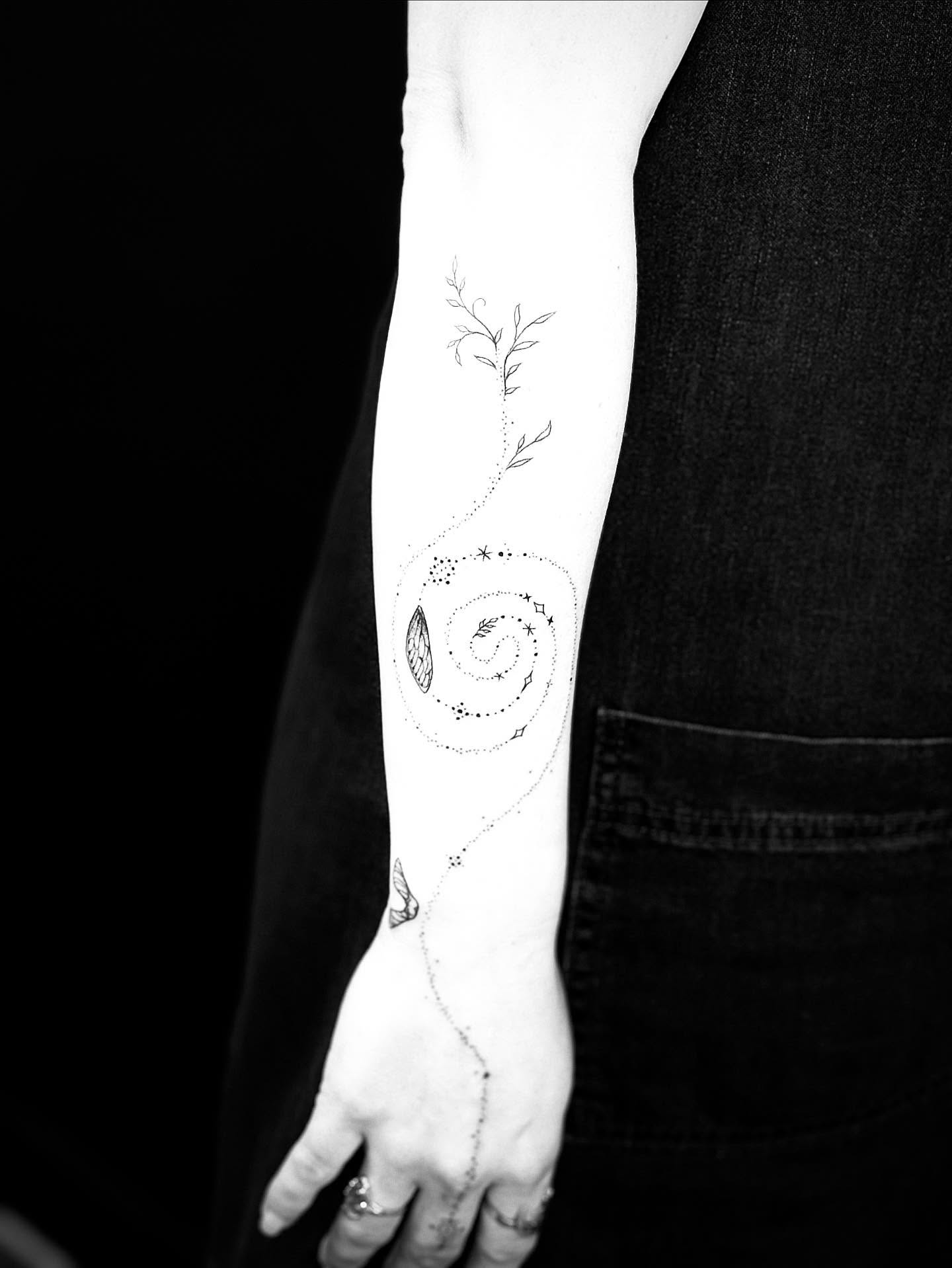 Swirl with leaves and stars dotwork tattoo on the forearm by Annie Mess