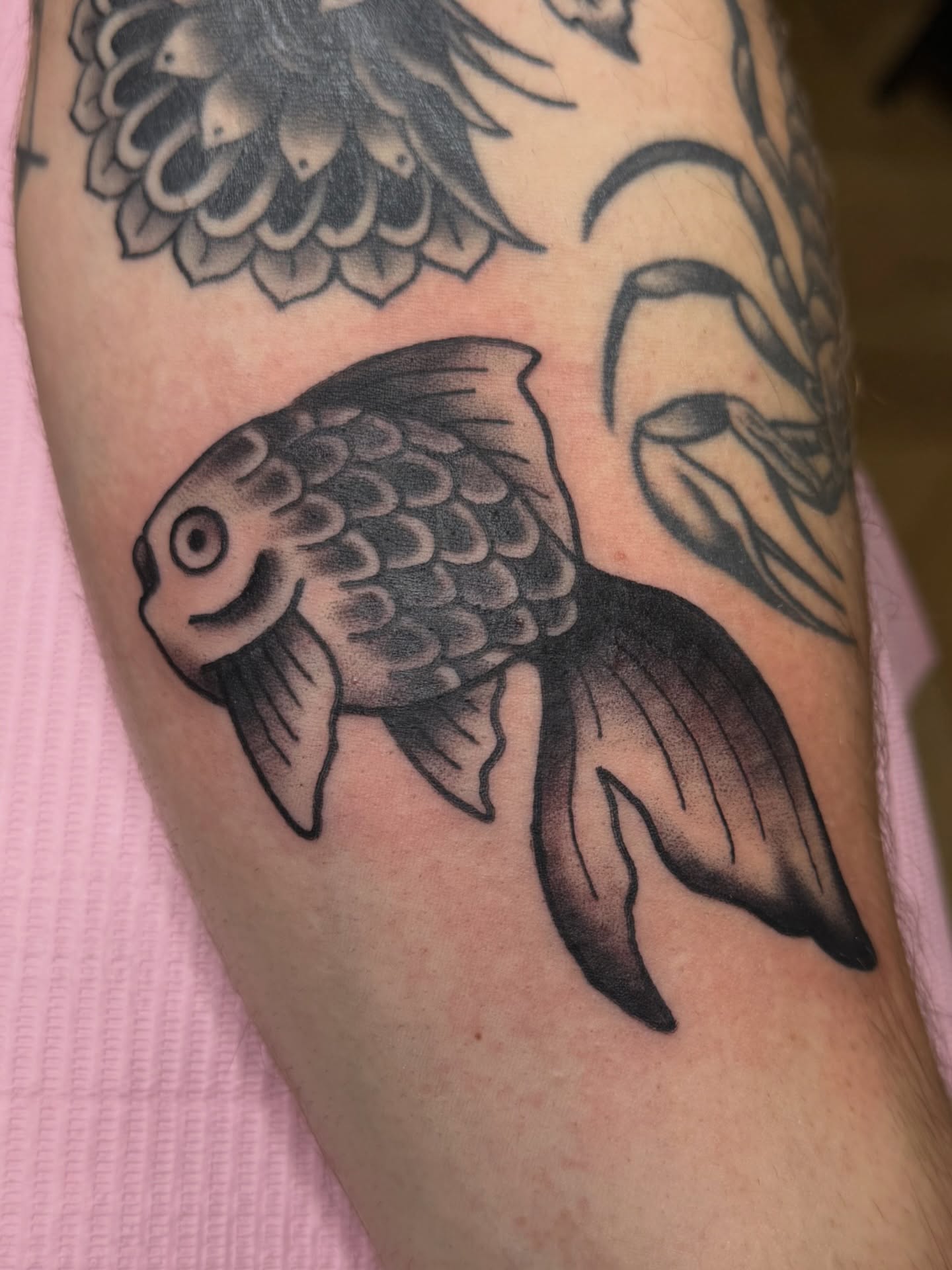 Goldfish black and grey tattoo on the forearm by Chloe Marie