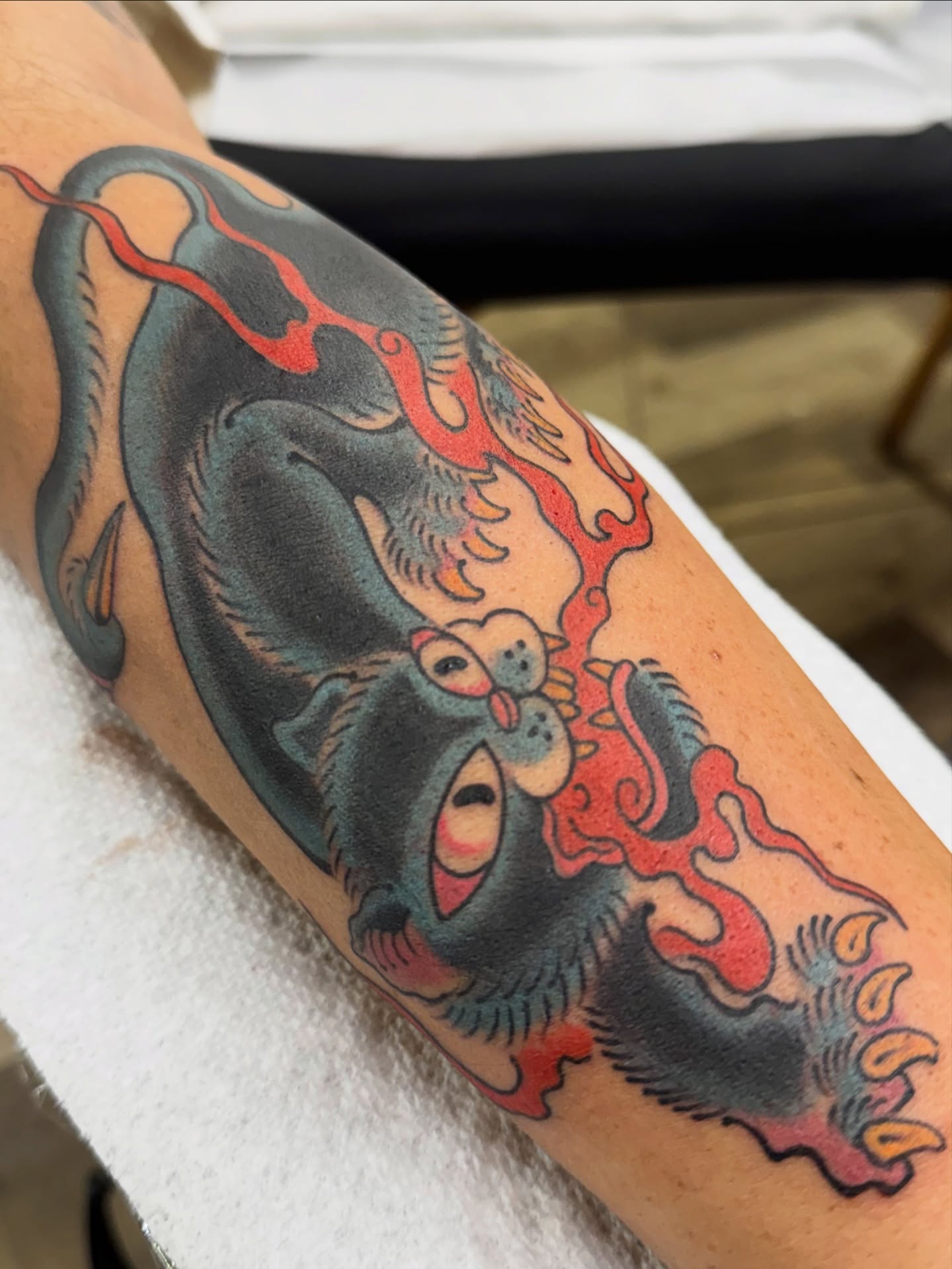 Cat with flames American traditional tattoo on the forearm by Chris Orta