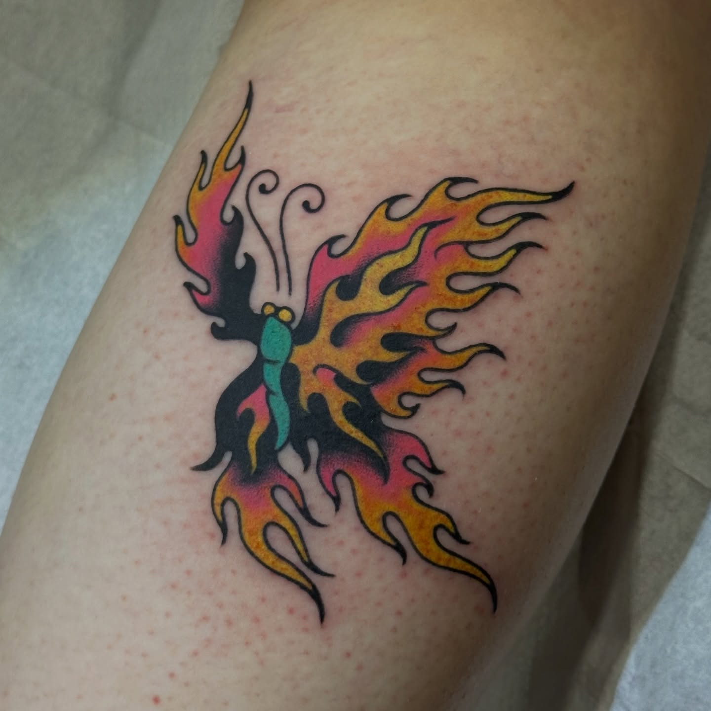 Flame phoenix American traditional tattoo on the thigh by kira